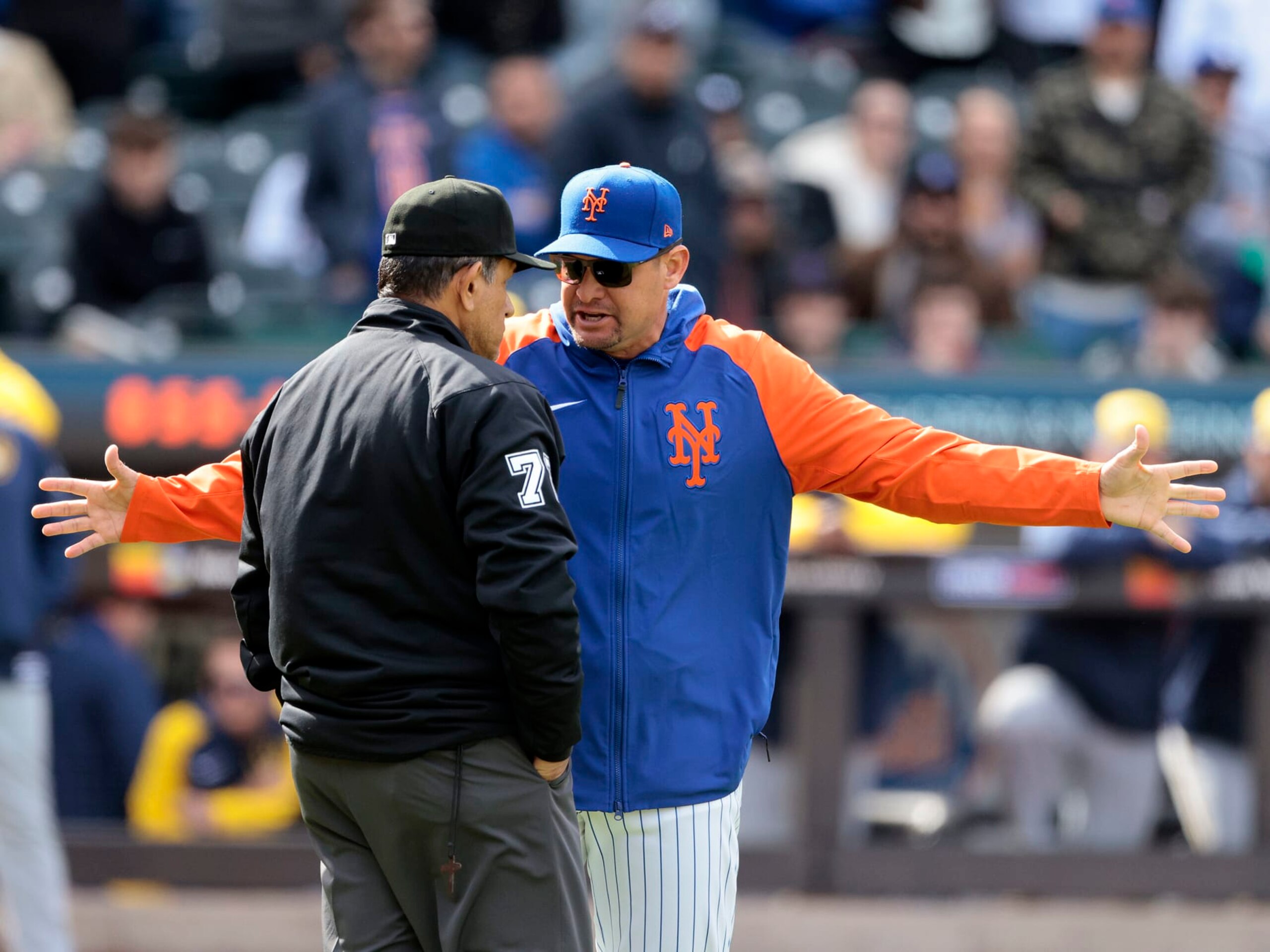 NEW YORK, NEW YORK - MARCH 30: Manager Carlos Mendoza #64 of the New York Mets argues with umpire Alfonso Marquez #72 after pitcher Yohan Ramírez #46 of the New York Mets was ejected for throwing at Rhys Hoskins #12 of the Milwaukee Brewers during the top of the seventh inning at Citi Field on March 30, 2024 in New York City. (Photo by Christopher Pasatieri/Getty Images)