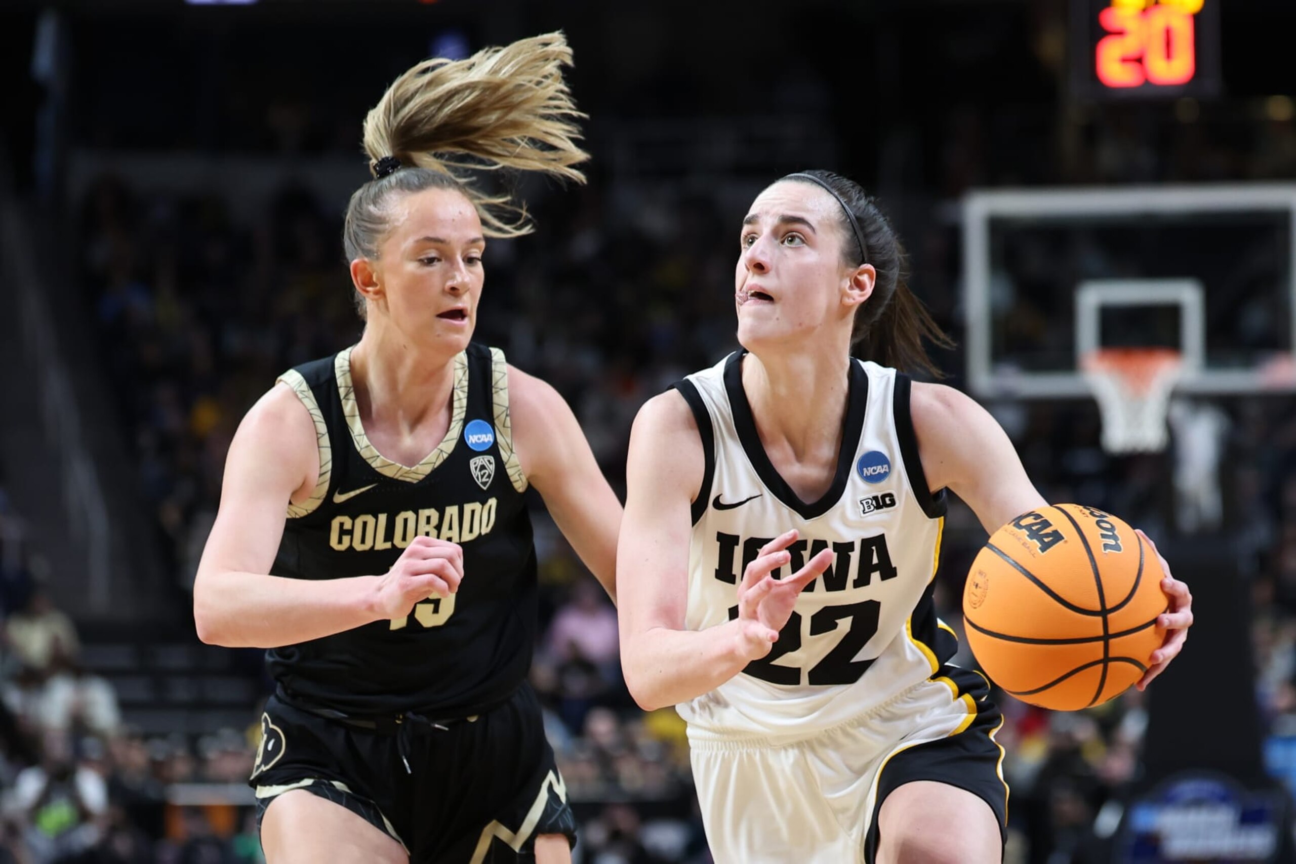 ALBANY, NEW YORK - MARCH 30: Caitlin Clark #22 of the Iowa Hawkeyes dribbles down the court and is defended by Kindyll Wetta #15 of the Colorado Buffaloes  during the Sweet Sixteen round of the 2024 NCAA Women's Basketball Tournament held at MVP Arena on March 30, 2024 in Albany, New York. (Photo by Scott Taetsch/NCAA Photos via Getty Images)