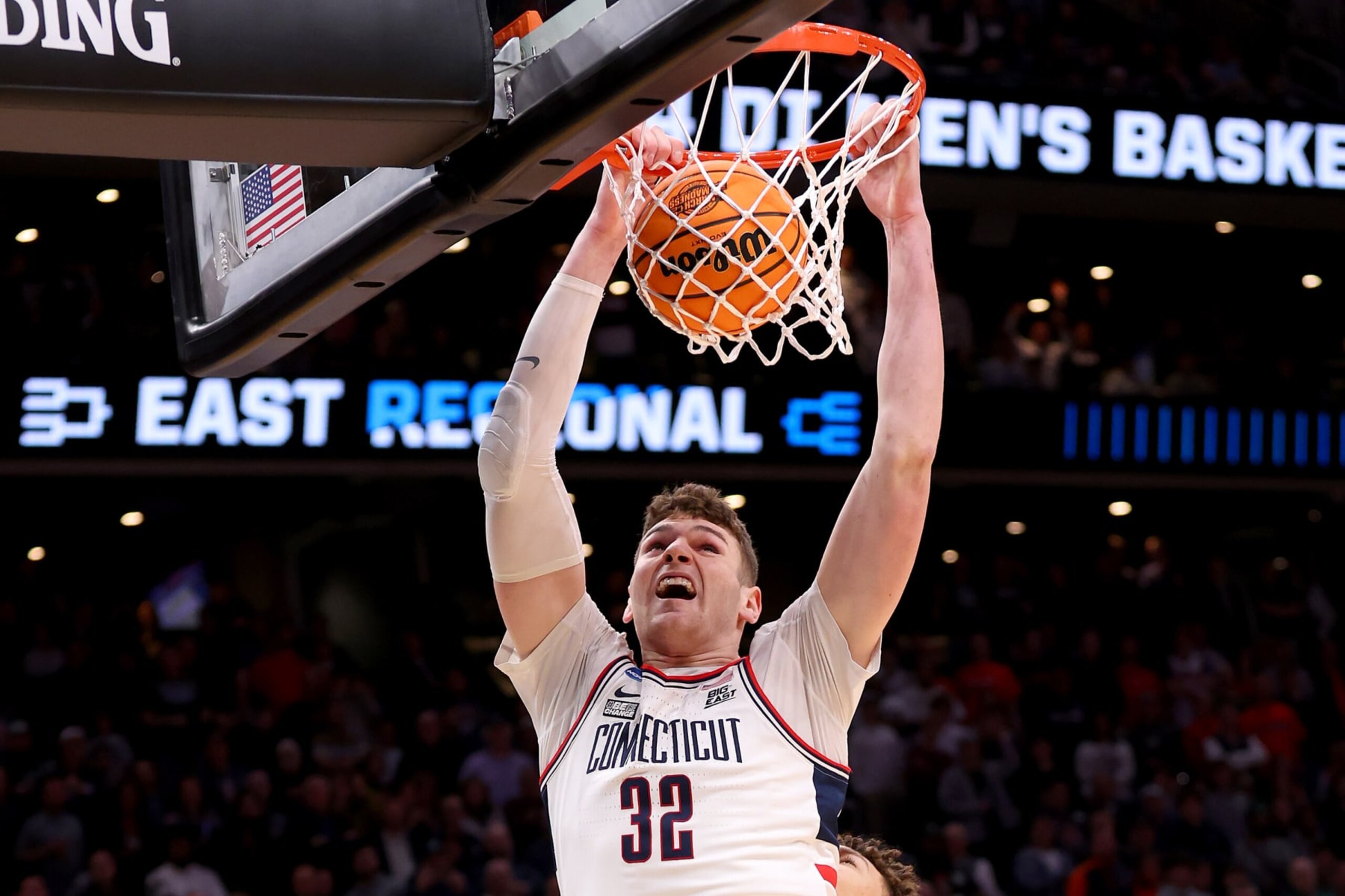 BOSTON, MASSACHUSETTS - MARCH 30: Donovan Clingan #32 of the Connecticut Huskies dunks the ball against the Illinois Fighting Illini in the Elite 8 round of the NCAA Men's Basketball Tournament at TD Garden on March 30, 2024 in Boston, Massachusetts. (Photo by Michael Reaves/Getty Images) BOSTON, MASSACHUSETTS - MARCH 30: Donovan Clingan #32 of the Connecticut Huskies dunks the ball against the Illinois Fighting Illini in the Elite 8 round of the NCAA Men's Basketball Tournament at TD Garden on March 30, 2024 in Boston, Massachusetts. (Photo by Michael Reaves/Getty Images)