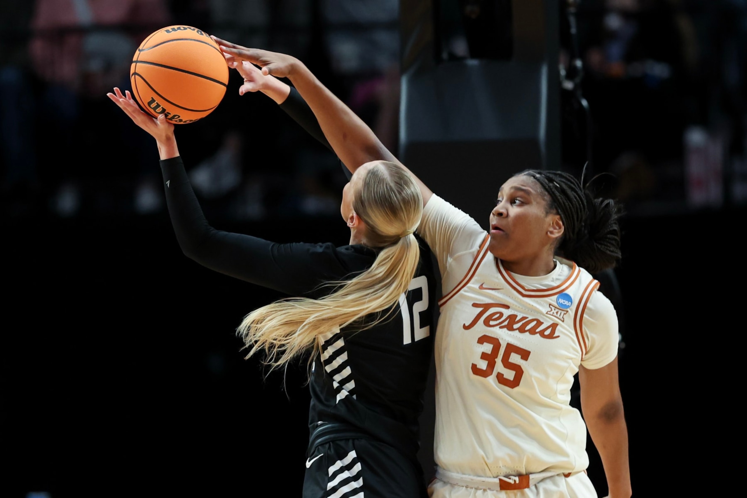 PORTLAND, OREGON - MARCH 29: Madison Booker #35 of the Texas Longhorns blocks Eliza Hollingsworth #12 of the Gonzaga Bulldogs during the second half in the Sweet 16 round of the NCAA Women's Basketball Tournament at Moda Center on March 29, 2024 in Portland, Oregon. (Photo by Steph Chambers/Getty Images)