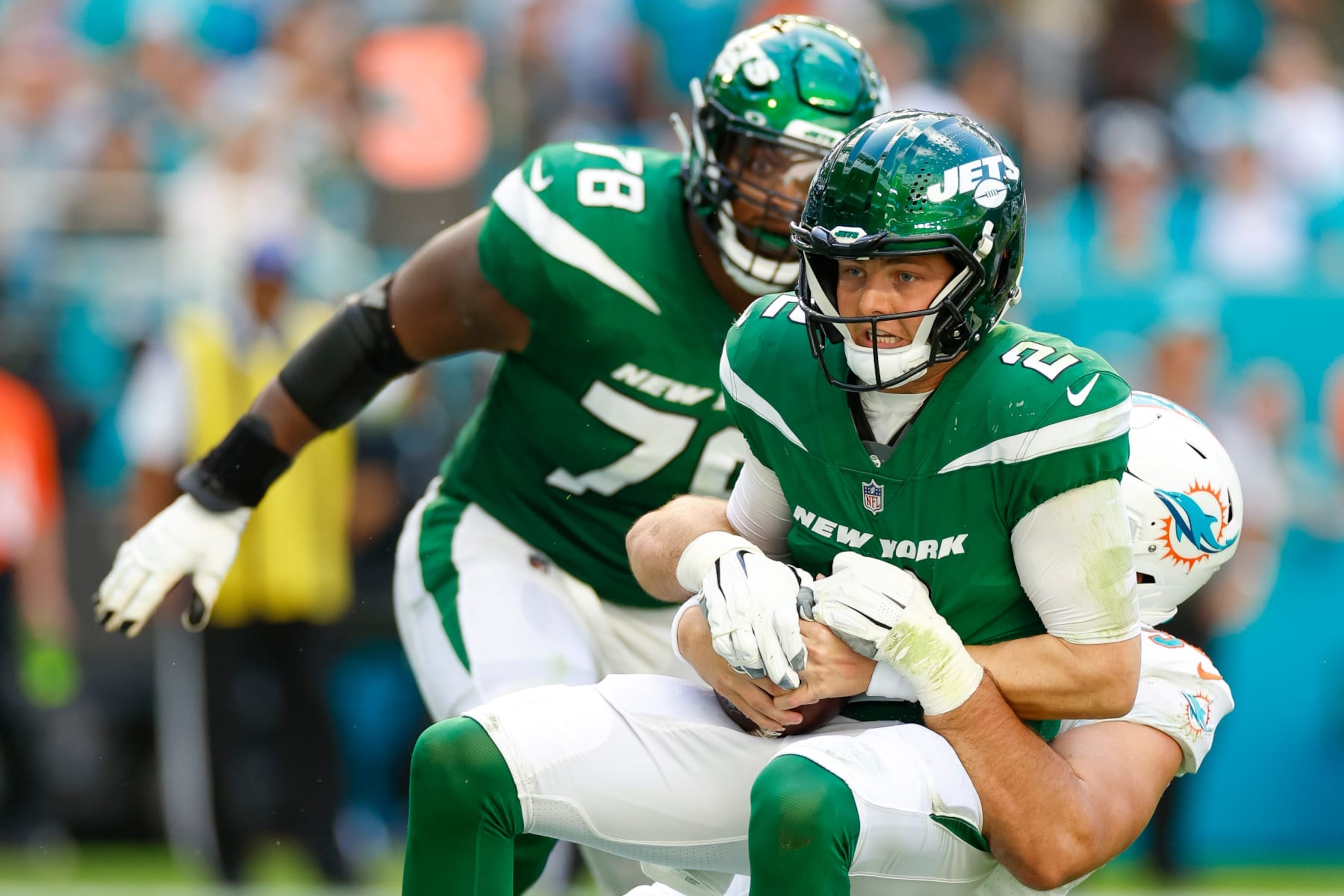 MIAMI GARDENS, FLORIDA - DECEMBER 17: Zach Sieler #92 of the Miami Dolphins sacks Zach Wilson #2 of the New York Jets in the first half of a game at Hard Rock Stadium on December 17, 2023 in Miami Gardens, Florida. (Photo by Brandon Sloter/Image Of Sport/Getty Images)