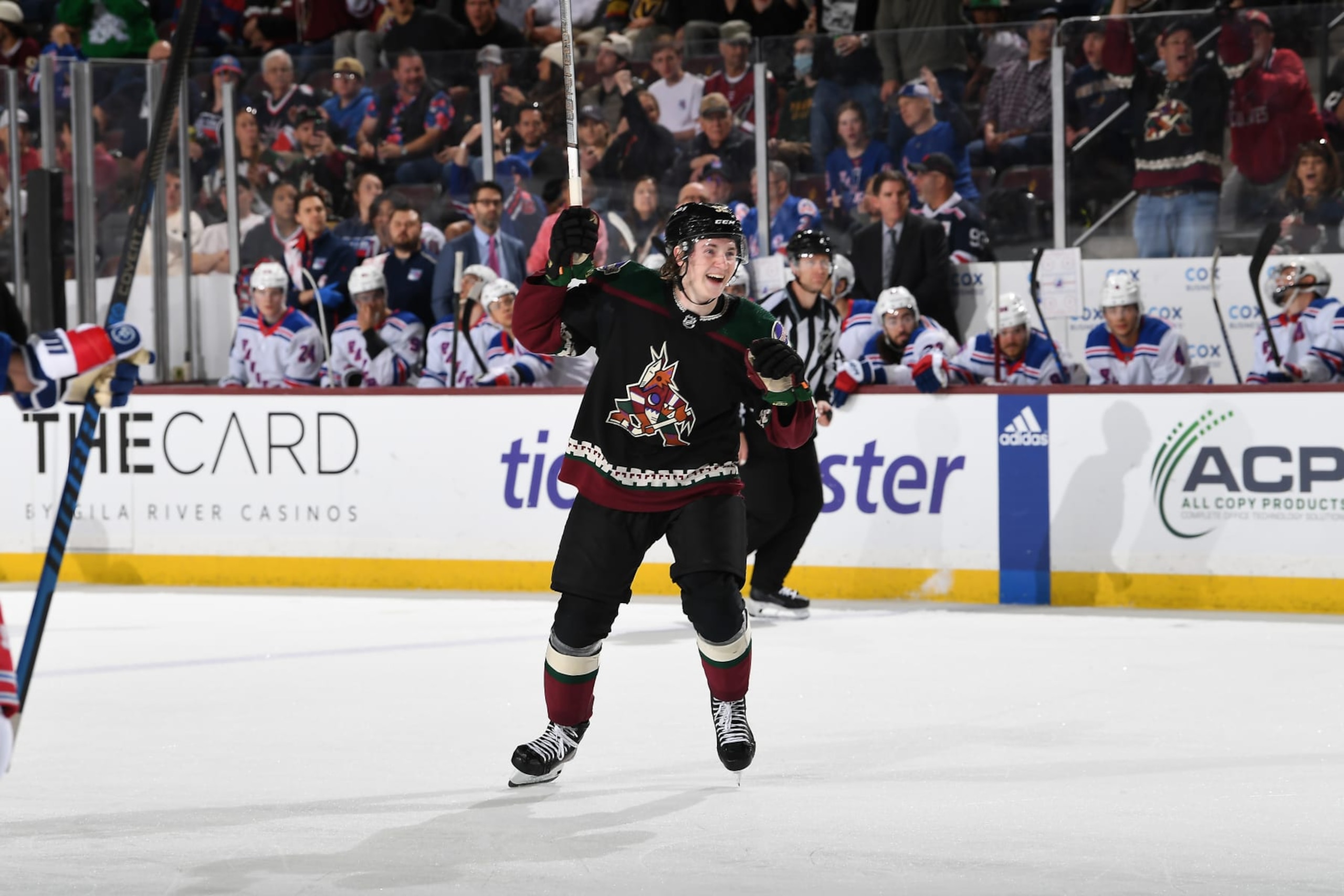 TEMPE, ARIZONA - MARCH 30: Logan Cooley #92 of the Arizona Coyotes celebrates after scoring a goal against the New York Rangers during the third period of the game at Mullett Arena on March 30, 2024 in Tempe, Arizona. (Photo by Norm Hall/NHLI via Getty Images)