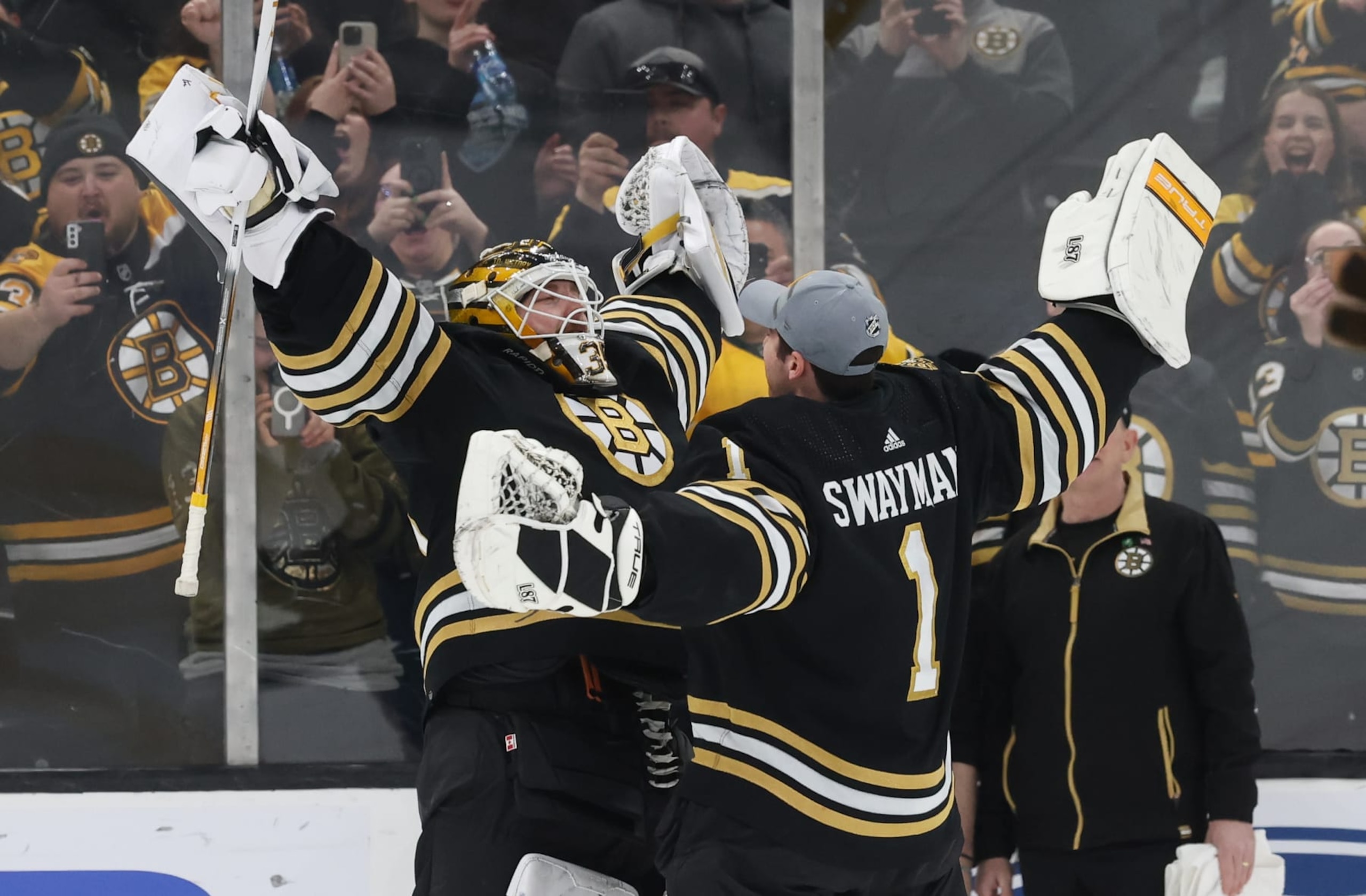 BOSTON, MASSACHUSETTS - MARCH 19: Linus Ullmark #35 of the Boston Bruins celebrates a 6-2 win against the Ottawa Senators with teammate Jeremy Swayman #1 at the TD Garden on March 19, 2024 in Boston, Massachusetts. (Photo by Richard T Gagnon/Getty Images)