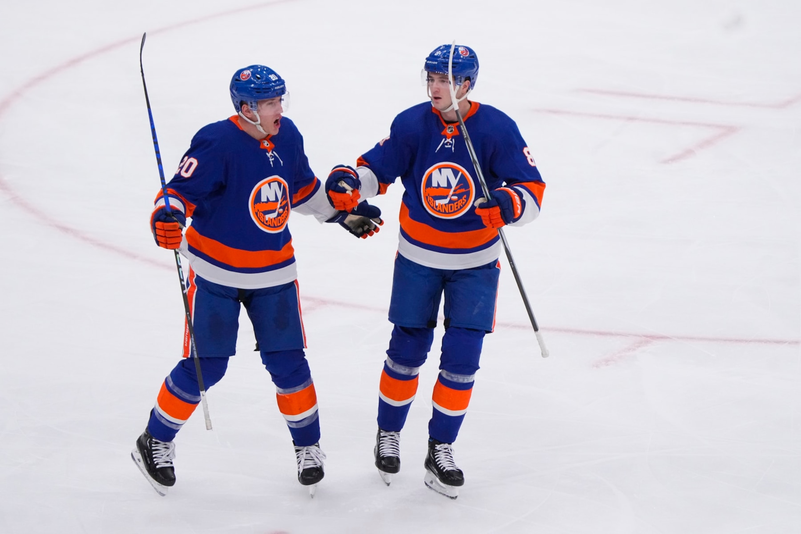 ELMONT, NY - JANUARY 21: New York Islanders Defenseman Noah Dobson (8) congratulates New York Islanders Right Wing Hudson Fasching (20) for scoring a goal during the third period of the National Hockey League game between the Dallas Stars and the New York Islanders on January 21, 2024, at UBS Arena in Elmont, NY. (Photo by Gregory Fisher/Icon Sportswire via Getty Images)