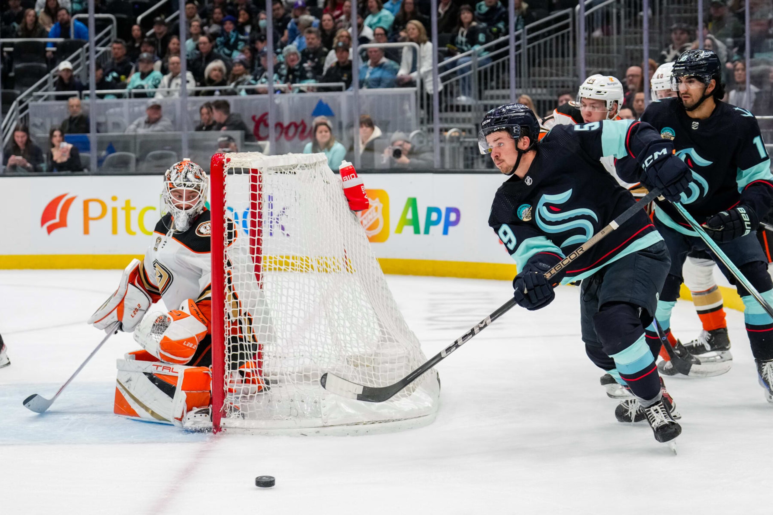 SEATTLE, WASHINGTON - MARCH 28: Logan Morrison #59 of the Seattle Kraken pushes the puck during the third period of a game against the Anaheim Ducks at Climate Pledge Arena on March 38, 2024 in Seattle, Washington. (Photo by Christopher Mast/NHLI via Getty Images)