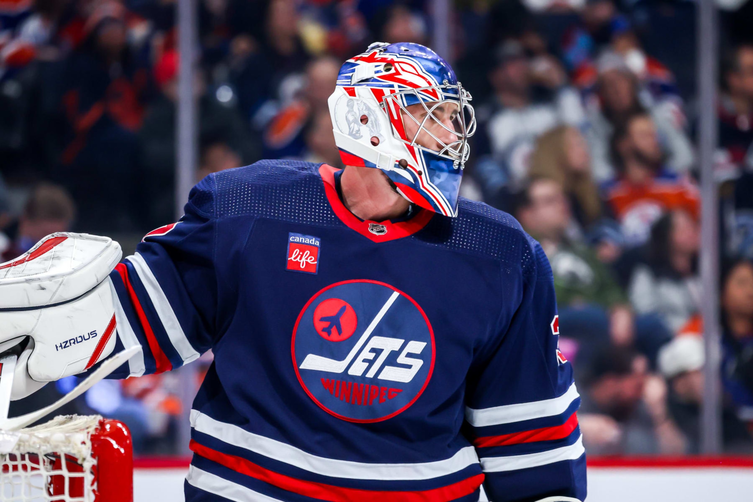 WINNIPEG, CANADA - MARCH 26: Goaltender Connor Hellebuyck #37 of the Winnipeg Jets looks on during a first period stoppage in play against the Edmonton Oilers at the Canada Life Centre on March 26, 2024 in Winnipeg, Manitoba, Canada. (Photo by Jonathan Kozub/NHLI via Getty Images)