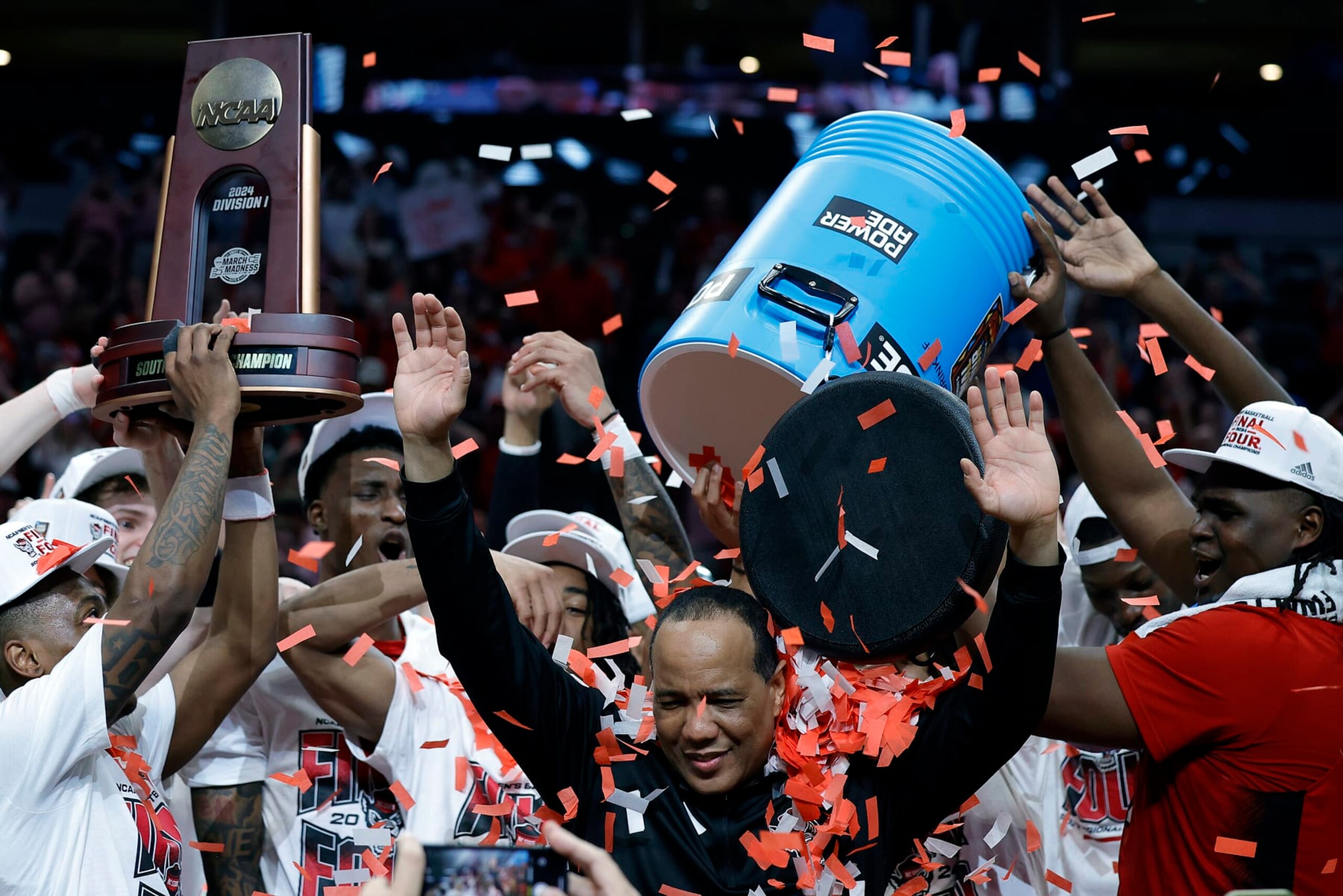 DALLAS, TEXAS - MARCH 31:  Head coach Kevin Keatts of the North Carolina State Wolfpack is doused with confetti as players celebrate after the Wolfpack defeated the Duke Blue Devils to advance to the Final Four after the Elite 8 round of the NCAA Men's Basketball Tournament at American Airlines Center on March 31, 2024 in Dallas, Texas. (Photo by Carmen Mandato/Getty Images)