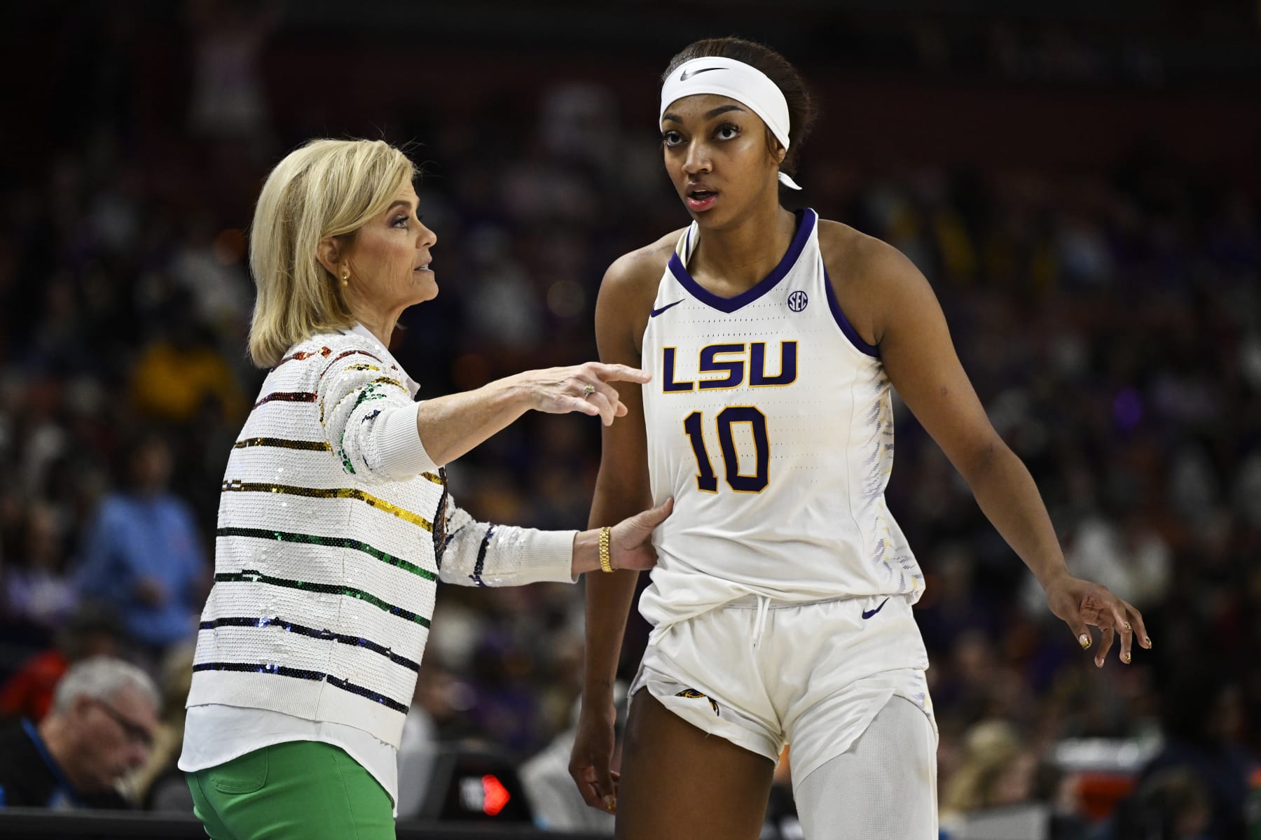 GREENVILLE, SOUTH CAROLINA - MARCH 09: Head coach Kim Mulkey of the LSU Lady Tigers talks with Angel Reese #10 against the Ole Miss Rebels in the fourth quarter during the semifinals of the SEC Women's Basketball Tournament at Bon Secours Wellness Arena on March 09, 2024 in Greenville, South Carolina.  (Photo by Eakin Howard/Getty Images)