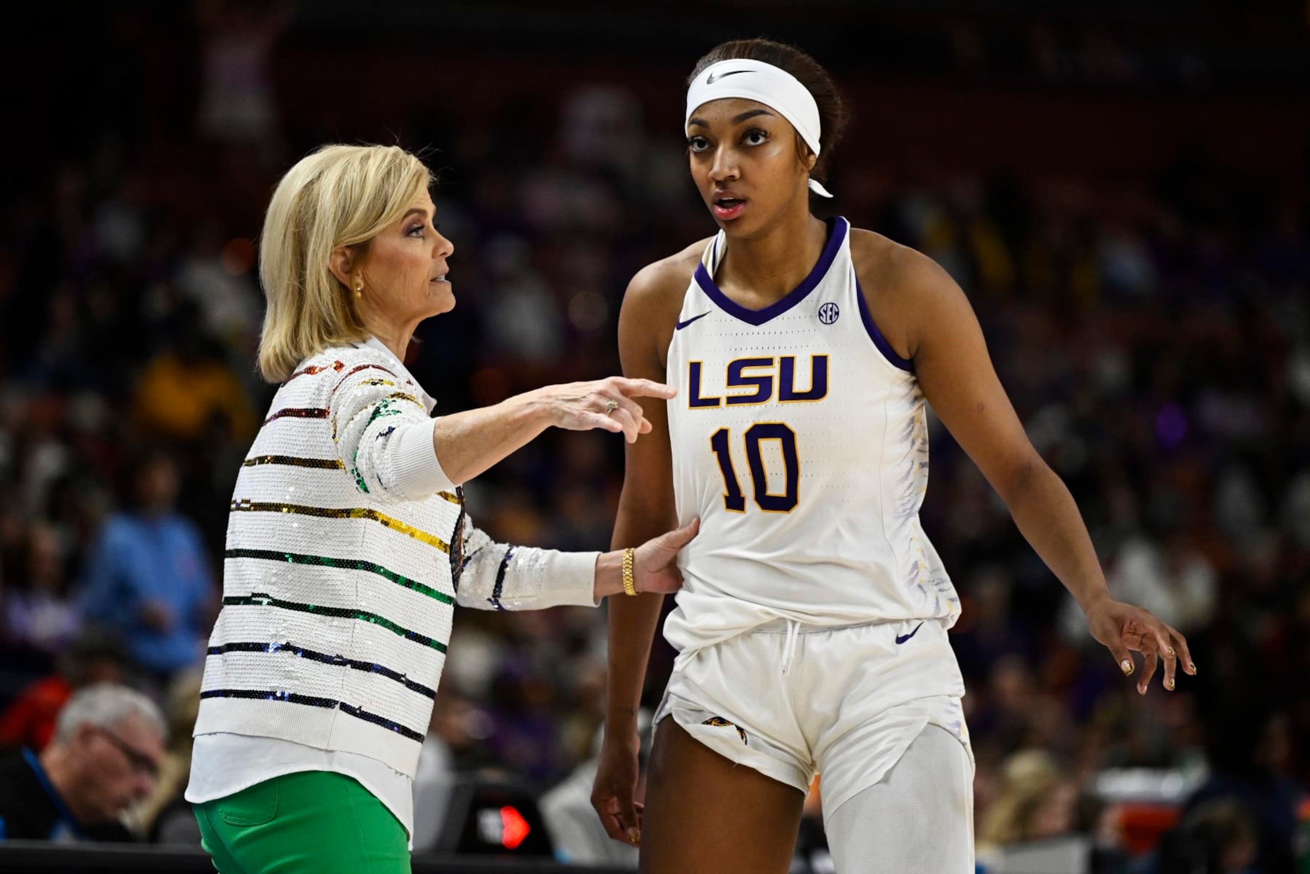 GREENVILLE, SOUTH CAROLINA - MARCH 09: Head coach Kim Mulkey of the LSU Lady Tigers talks with Angel Reese #10 against the Ole Miss Rebels in the fourth quarter during the semifinals of the SEC Women's Basketball Tournament at Bon Secours Wellness Arena on March 09, 2024 in Greenville, South Carolina.  (Photo by Eakin Howard/Getty Images)