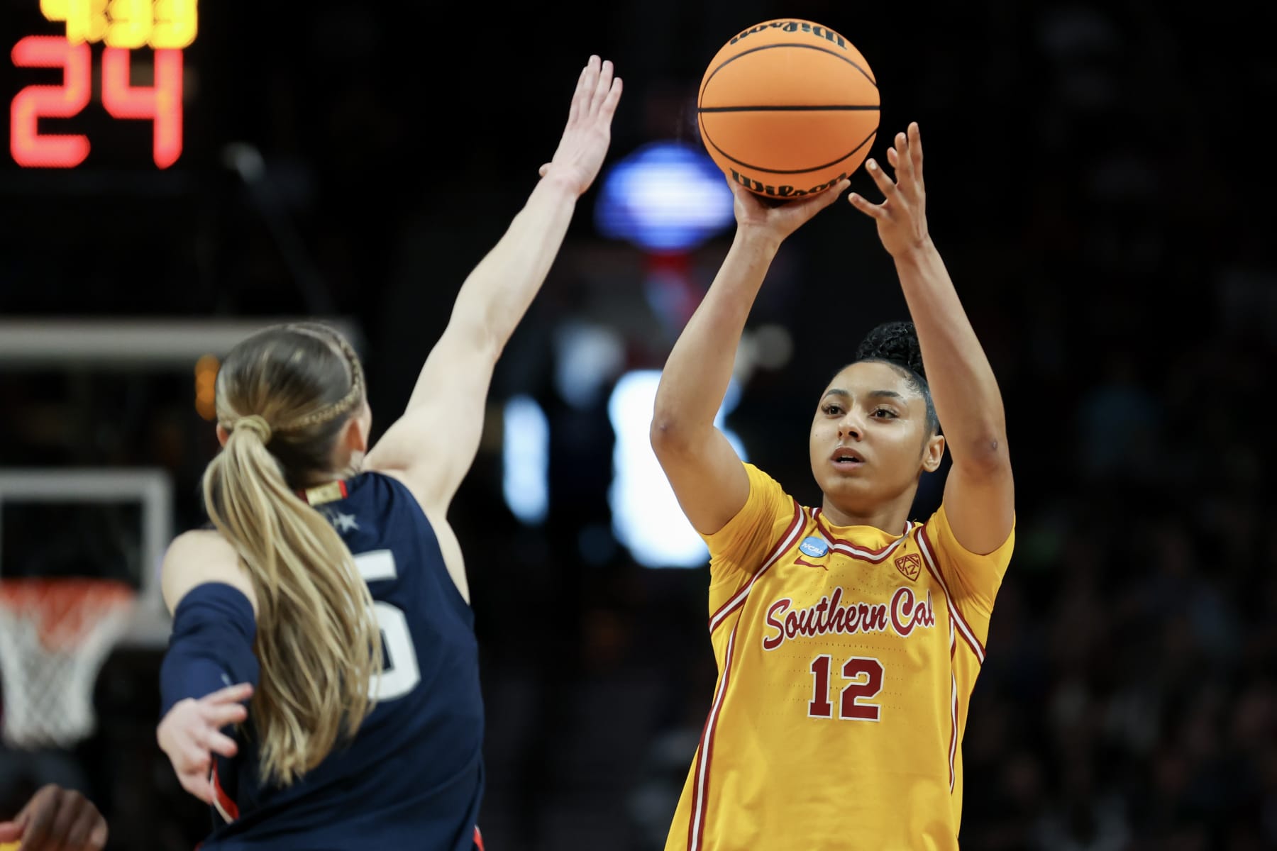 PORTLAND, OREGON - APRIL 01: JuJu Watkins #12 of the USC Trojans shoots over Paige Bueckers #5 of the Connecticut Huskies during the first half in the Elite 8 round of the NCAA Women's Basketball Tournament at Moda Center on April 01, 2024 in Portland, Oregon. (Photo by Steph Chambers/Getty Images)