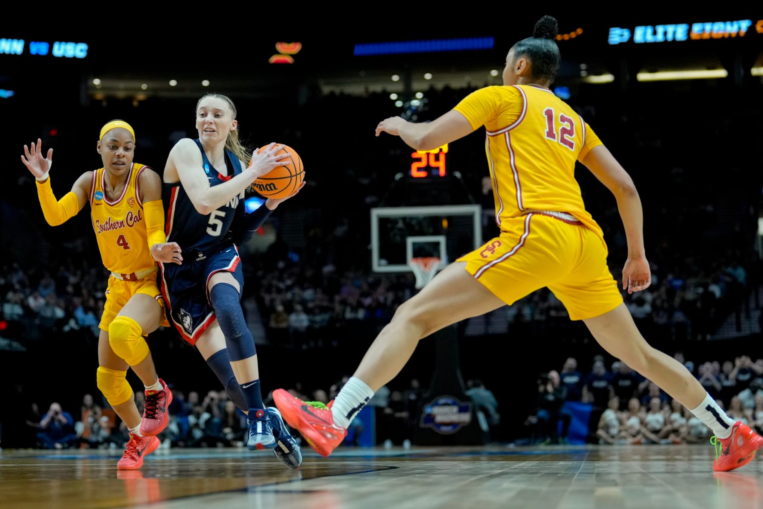 PORTLAND, OREGON - APRIL 01: Paige Bueckers #5 of the Connecticut Huskies drives past Kayla Williams #4 of the USC Trojansduring the first half in the Elite 8 round of the NCAA Women's Basketball Tournament at Moda Center on April 01, 2024 in Portland, Oregon. (Photo by Soobum Im/Getty Images)