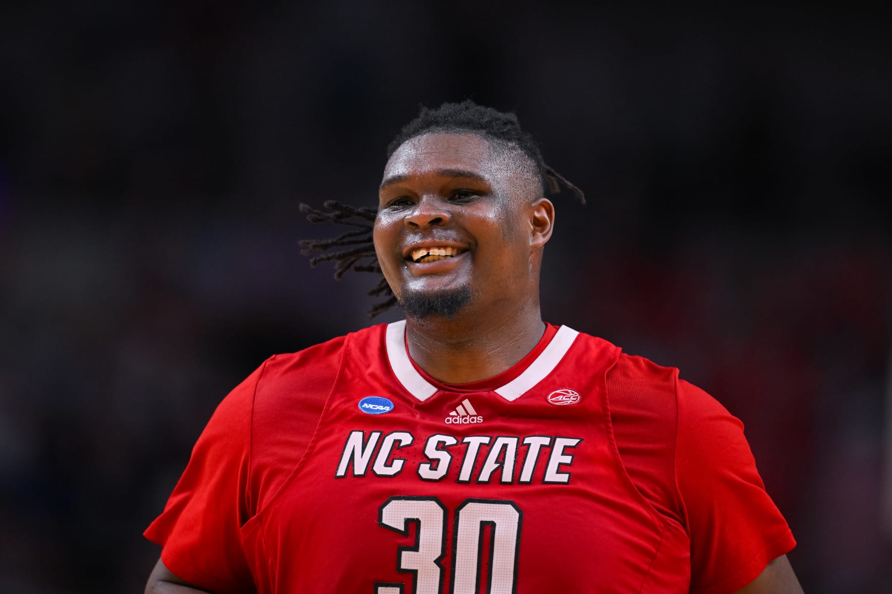 DALLAS, TEXAS - MARCH 31: DJ Burns Jr. #30 of the North Carolina State Wolfpack smiles down the court during the Elite Eight round of the 2024 NCAA Men's Basketball Tournament held at American Airlines Center on March 31, 2024 in Dallas, Texas. (Photo by Andy Hancock/NCAA Photos/NCAA Photos via Getty Images)