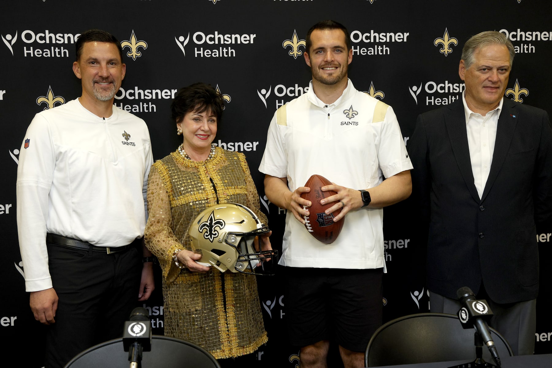 NEW ORLEANS, LOUISIANA - MARCH 11: (L-R) New Orleans Saints head coach Dennis Allen, Gayle Benson, owner of the New Orleans Saints and Derek Carr of the New Orleans Saints, and Mickey Loomis, General manager of the New Orleans Saints pose for a picture after signing a four-year contract with the Saints at New Orleans Saints Indoor Practice Facility on March 11, 2023 in New Orleans, Louisiana.  (Photo by Sean Gardner/Getty Images)