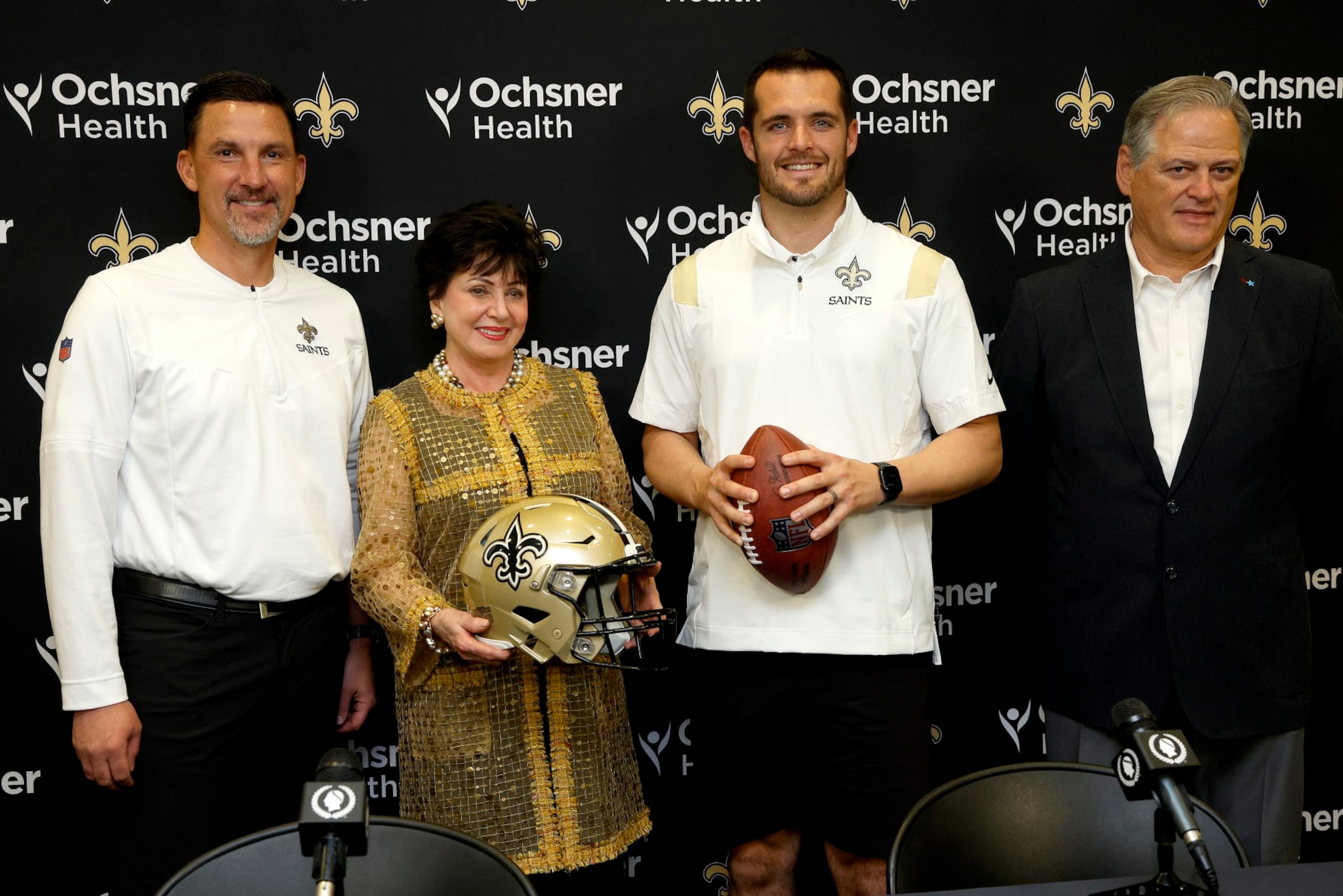 NEW ORLEANS, LOUISIANA - MARCH 11: (L-R) New Orleans Saints head coach Dennis Allen, Gayle Benson, owner of the New Orleans Saints and Derek Carr of the New Orleans Saints, and Mickey Loomis, General manager of the New Orleans Saints pose for a picture after signing a four-year contract with the Saints at New Orleans Saints Indoor Practice Facility on March 11, 2023 in New Orleans, Louisiana.  (Photo by Sean Gardner/Getty Images)