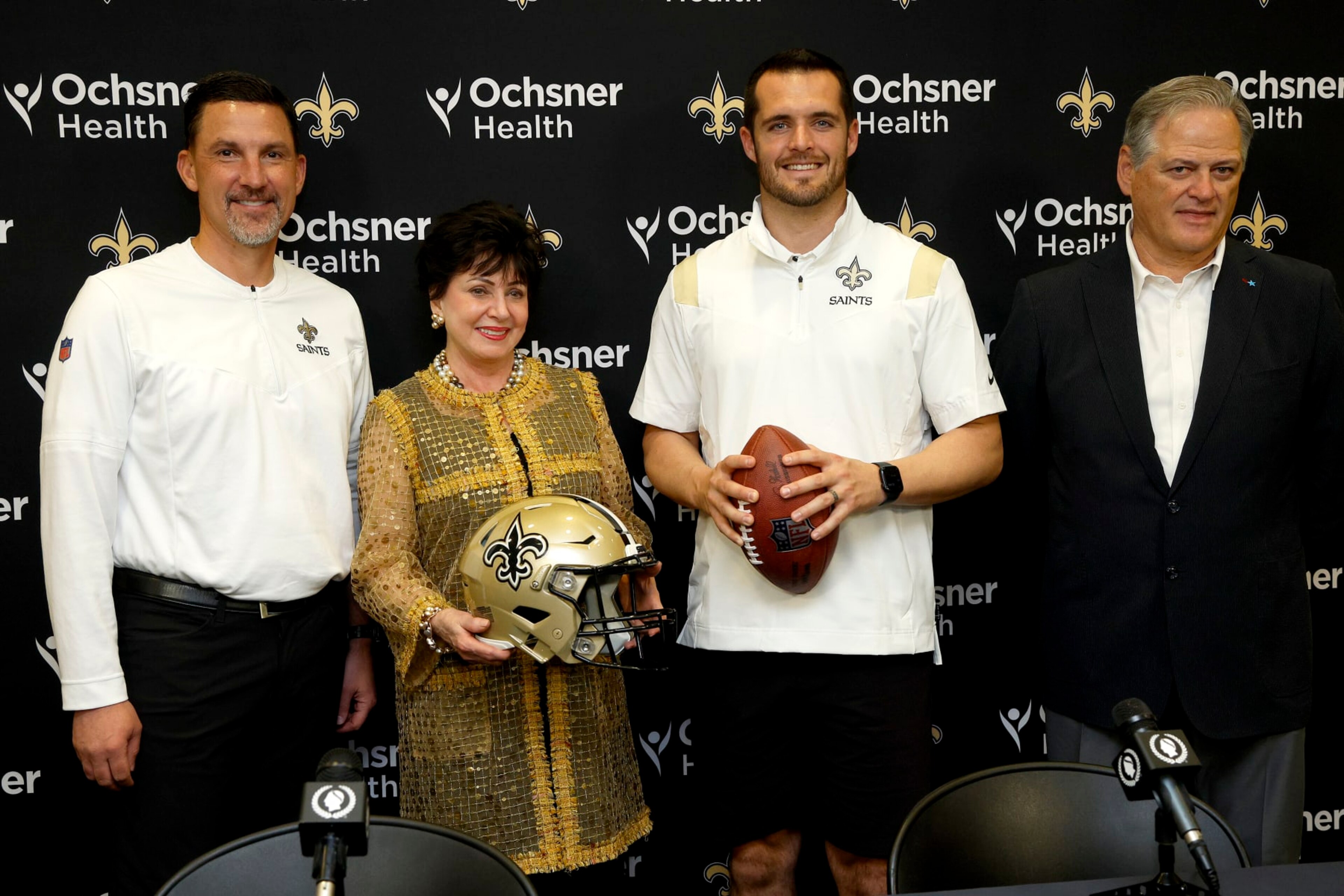 NEW ORLEANS, LOUISIANA - MARCH 11: (L-R) New Orleans Saints head coach Dennis Allen, Gayle Benson, owner of the New Orleans Saints and Derek Carr of the New Orleans Saints, and Mickey Loomis, General manager of the New Orleans Saints pose for a picture after signing a four-year contract with the Saints at New Orleans Saints Indoor Practice Facility on March 11, 2023 in New Orleans, Louisiana.  (Photo by Sean Gardner/Getty Images)