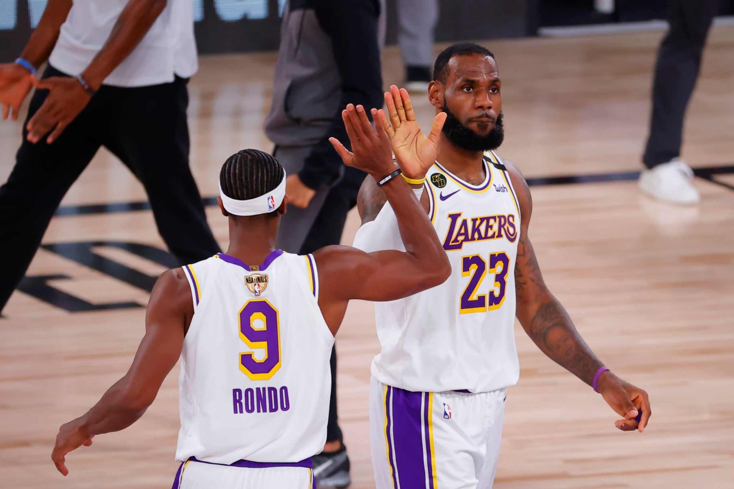 LAKE BUENA VISTA, FLORIDA - OCTOBER 04: LeBron James #23 of the Los Angeles Lakers high fives Rajon Rondo #9 during the second half against the Miami Heat in Game Three of the 2020 NBA Finals at AdventHealth Arena at ESPN Wide World Of Sports Complex on October 04, 2020 in Lake Buena Vista, Florida. NOTE TO USER: User expressly acknowledges and agrees that, by downloading and or using this photograph, User is consenting to the terms and conditions of the Getty Images License Agreement. (Photo by Kevin C. Cox/Getty Images)