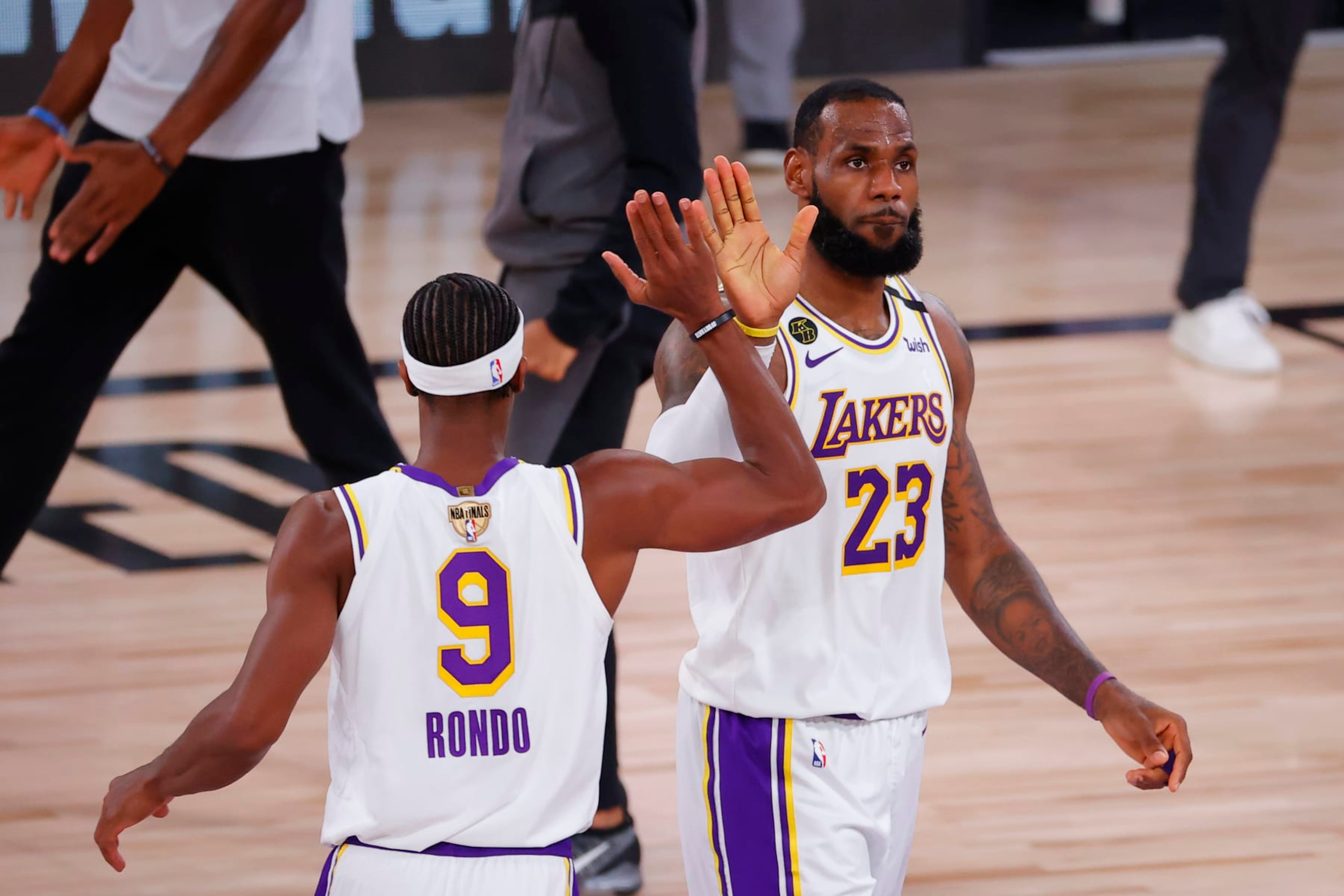 LAKE BUENA VISTA, FLORIDA - OCTOBER 04: LeBron James #23 of the Los Angeles Lakers high fives Rajon Rondo #9 during the second half against the Miami Heat in Game Three of the 2020 NBA Finals at AdventHealth Arena at ESPN Wide World Of Sports Complex on October 04, 2020 in Lake Buena Vista, Florida. NOTE TO USER: User expressly acknowledges and agrees that, by downloading and or using this photograph, User is consenting to the terms and conditions of the Getty Images License Agreement. (Photo by Kevin C. Cox/Getty Images)