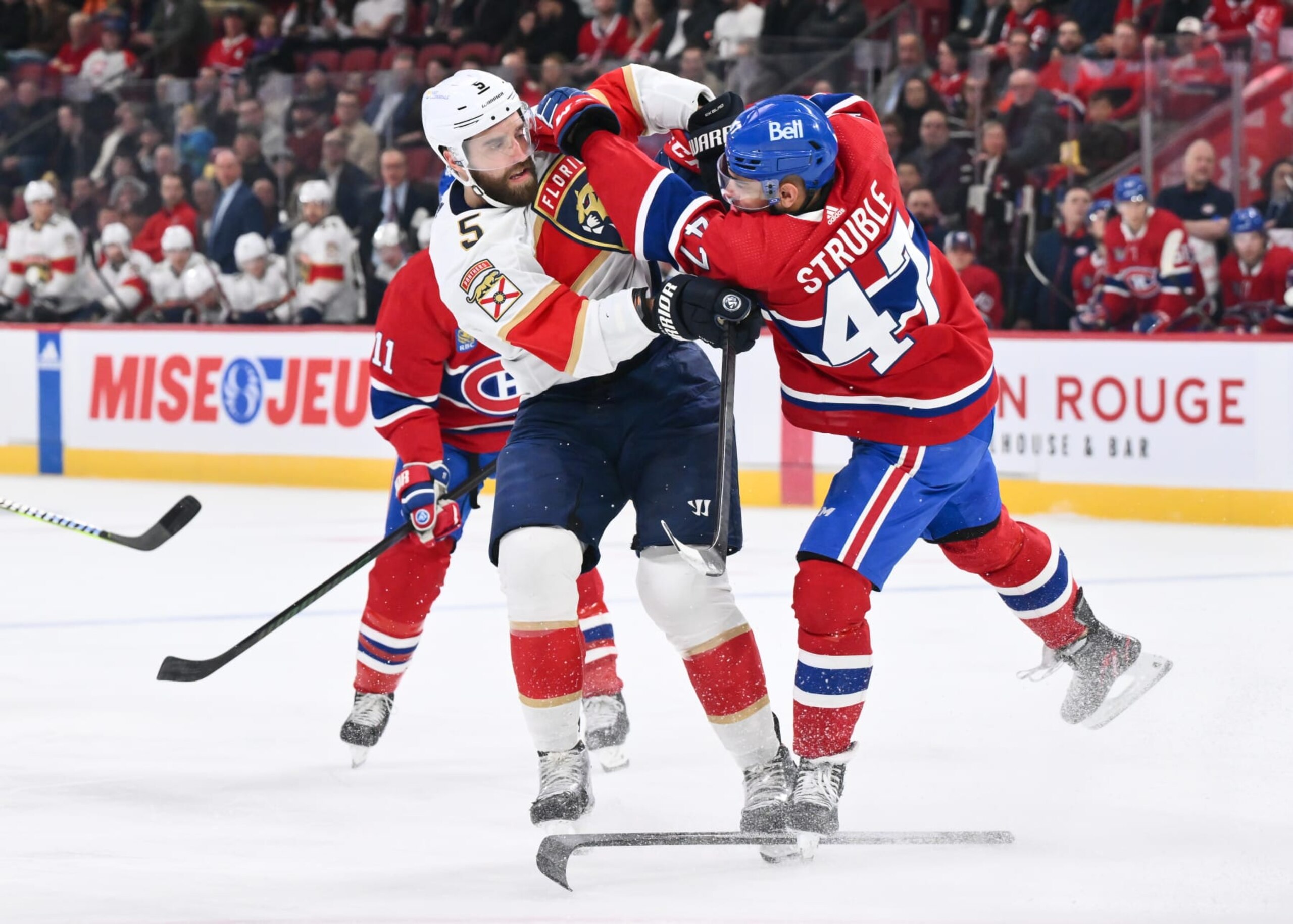 MONTREAL, CANADA - APRIL 02:  Jayden Struble #47 of the Montreal Canadiens defends against Aaron Ekblad #5 of the Florida Panthersduring the first period at the Bell Centre on April 2, 2024 in Montreal, Quebec, Canada.  (Photo by Minas Panagiotakis/Getty Images)
