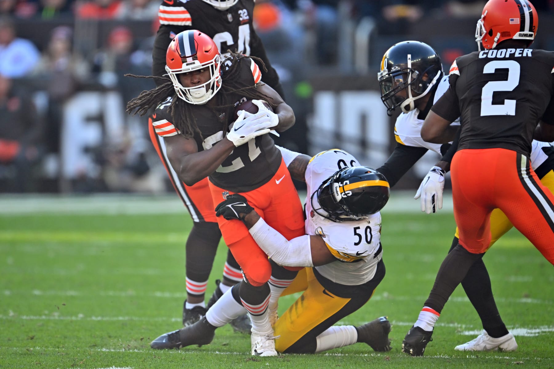 CLEVELAND, OHIO - NOVEMBER 19: Running back Kareem Hunt #27 of the Cleveland Browns is tackled by linebacker Elandon Roberts #50 of the Pittsburgh Steelers during the third quarter at Cleveland Browns Stadium on November 19, 2023 in Cleveland, Ohio. The Browns defeated the Steelers 13-10. (Photo by Jason Miller/Getty Images)