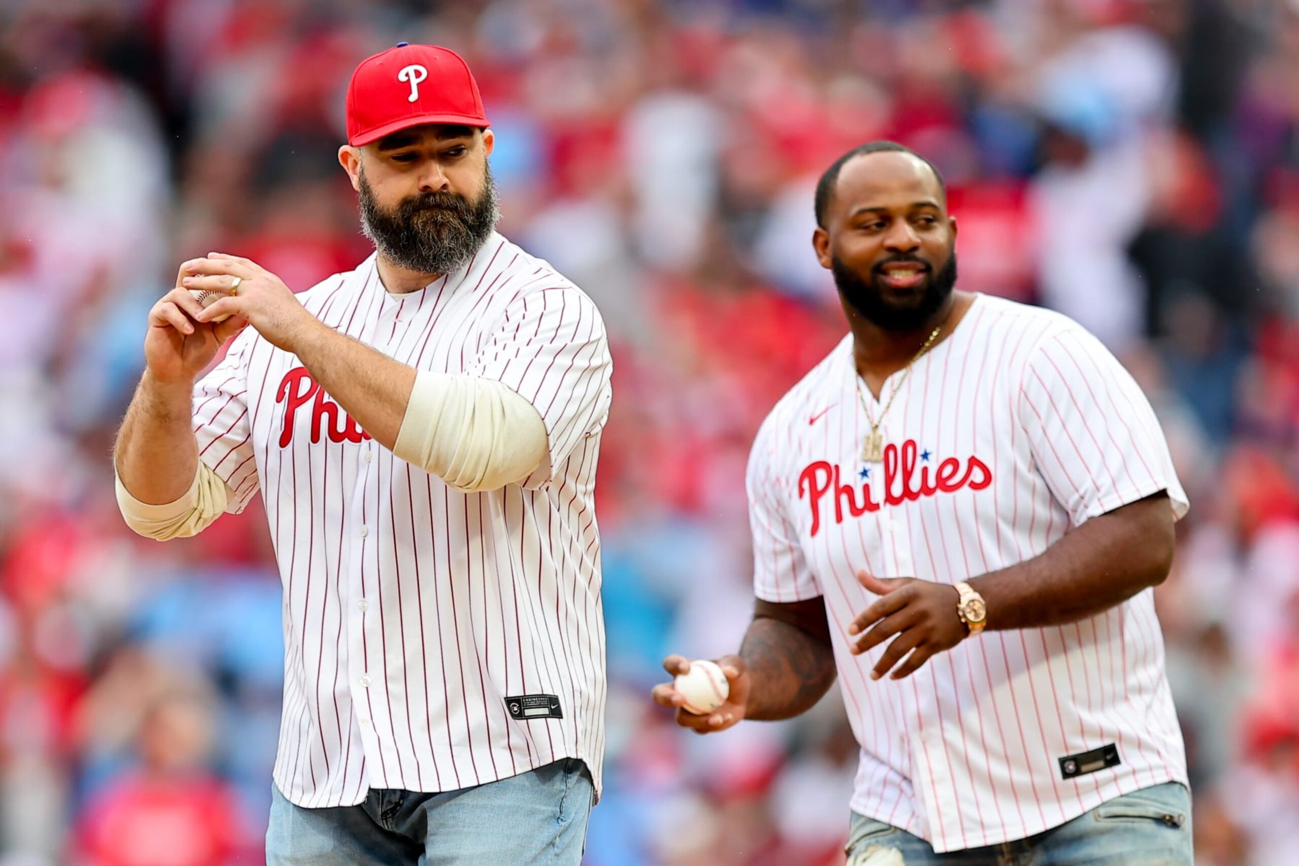 PHILADELPHIA, PA - MARCH 30: Jason Kelce former Philadelphia Eagle player throws out the ceremonial first pitch with Fletcher Cox of the Philadelphia Eagles prior to the game against the Atlanta Braves on March 30, 2024 at Citizens Bank Park in Philadelphia, Pennsylvania.  (Photo by Rich Graessle/Icon Sportswire via Getty Images)