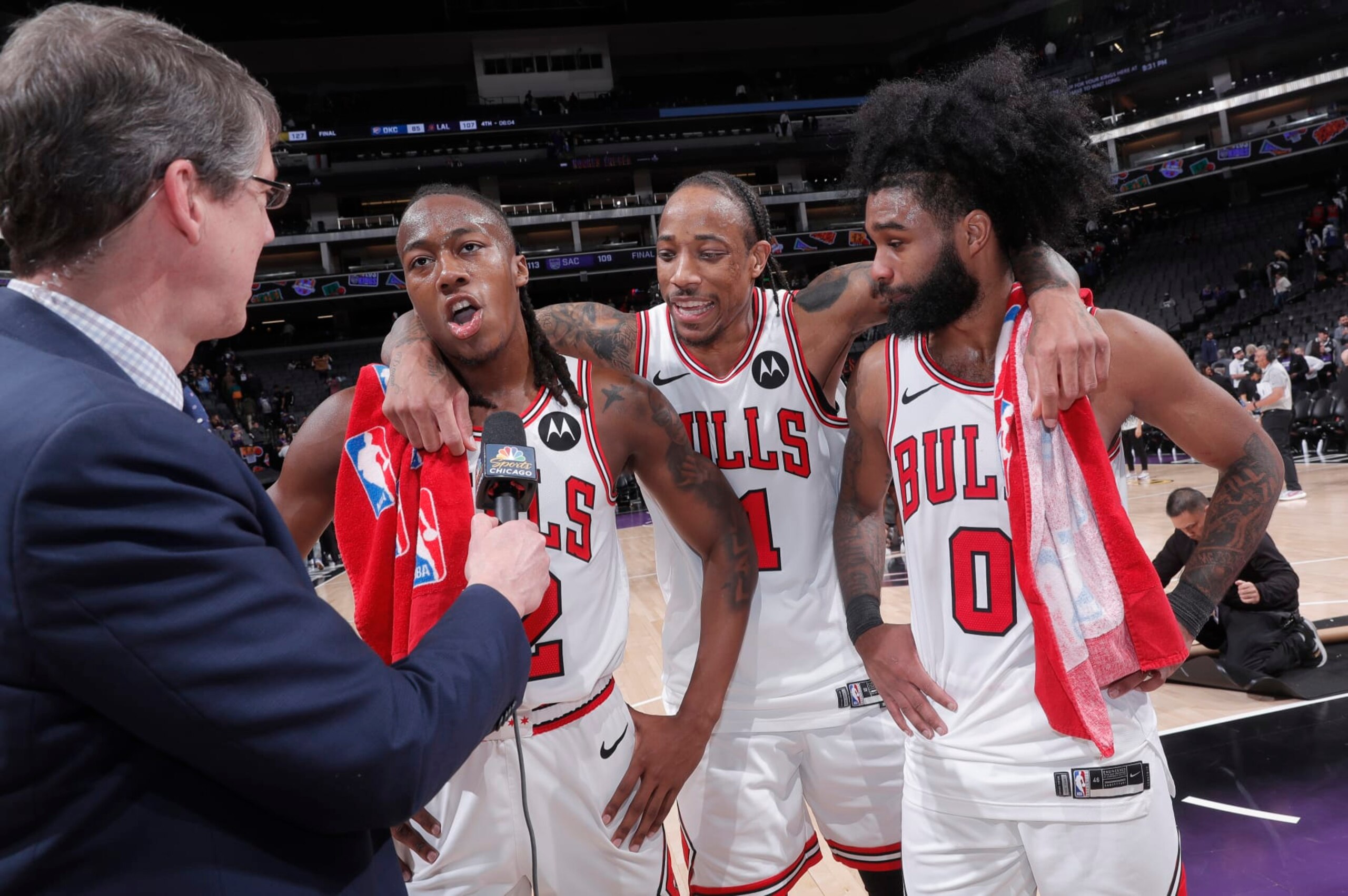 SACRAMENTO, CA - MARCH 4: Ayo Dosunmu #12 of the Chicago Bulls speaks with media while teammates DeMar DeRozan #11 and Coby White #0 look on after defeating the Sacramento Kings on March 4, 2024 at Golden 1 Center in Sacramento, California. NOTE TO USER: User expressly acknowledges and agrees that, by downloading and or using this photograph, User is consenting to the terms and conditions of the Getty Images Agreement. Mandatory Copyright Notice: Copyright 2024 NBAE (Photo by Rocky Widner/NBAE via Getty Images)
