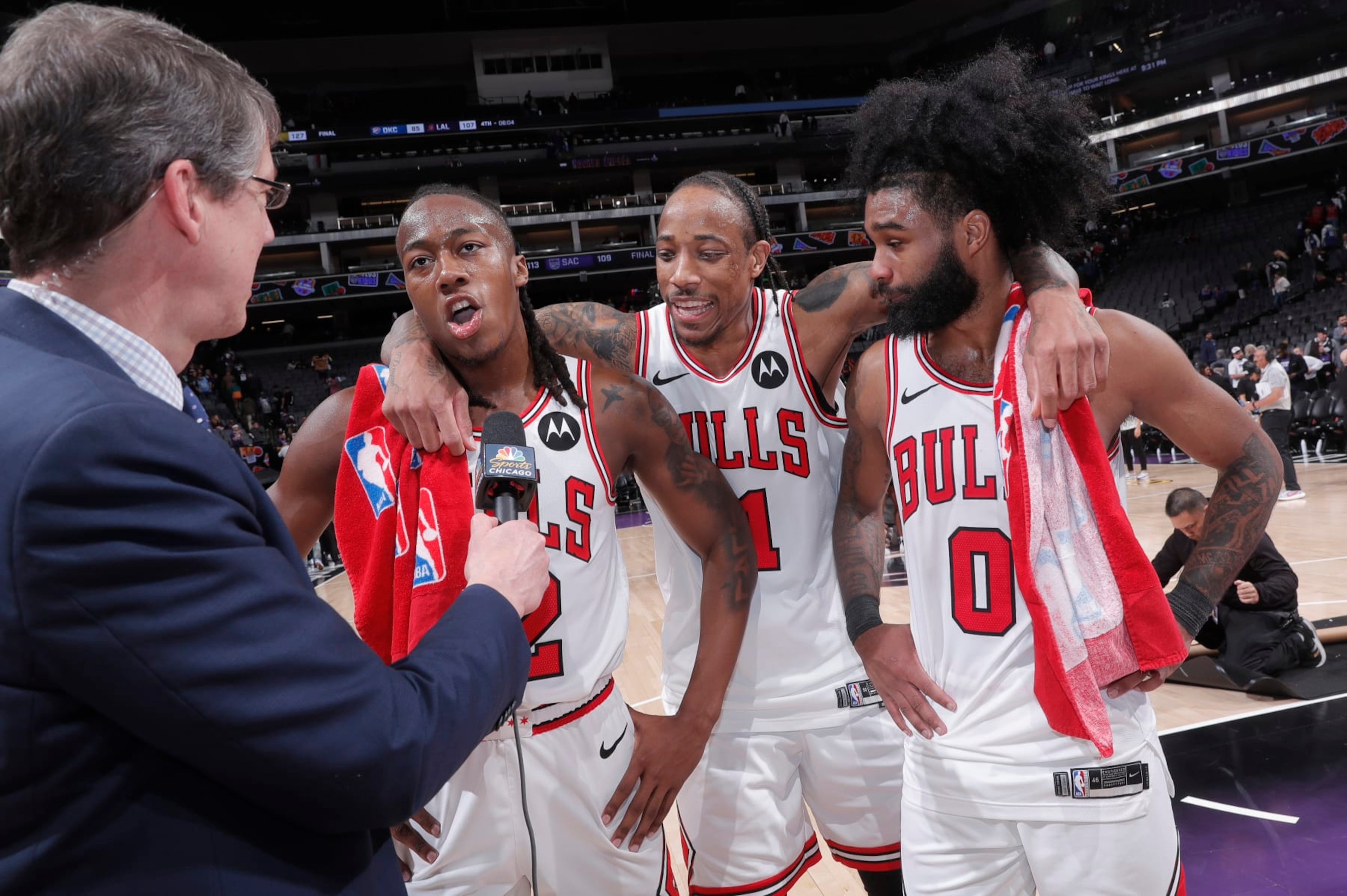 SACRAMENTO, CA - MARCH 4: Ayo Dosunmu #12 of the Chicago Bulls speaks with media while teammates DeMar DeRozan #11 and Coby White #0 look on after defeating the Sacramento Kings on March 4, 2024 at Golden 1 Center in Sacramento, California. NOTE TO USER: User expressly acknowledges and agrees that, by downloading and or using this photograph, User is consenting to the terms and conditions of the Getty Images Agreement. Mandatory Copyright Notice: Copyright 2024 NBAE (Photo by Rocky Widner/NBAE via Getty Images)