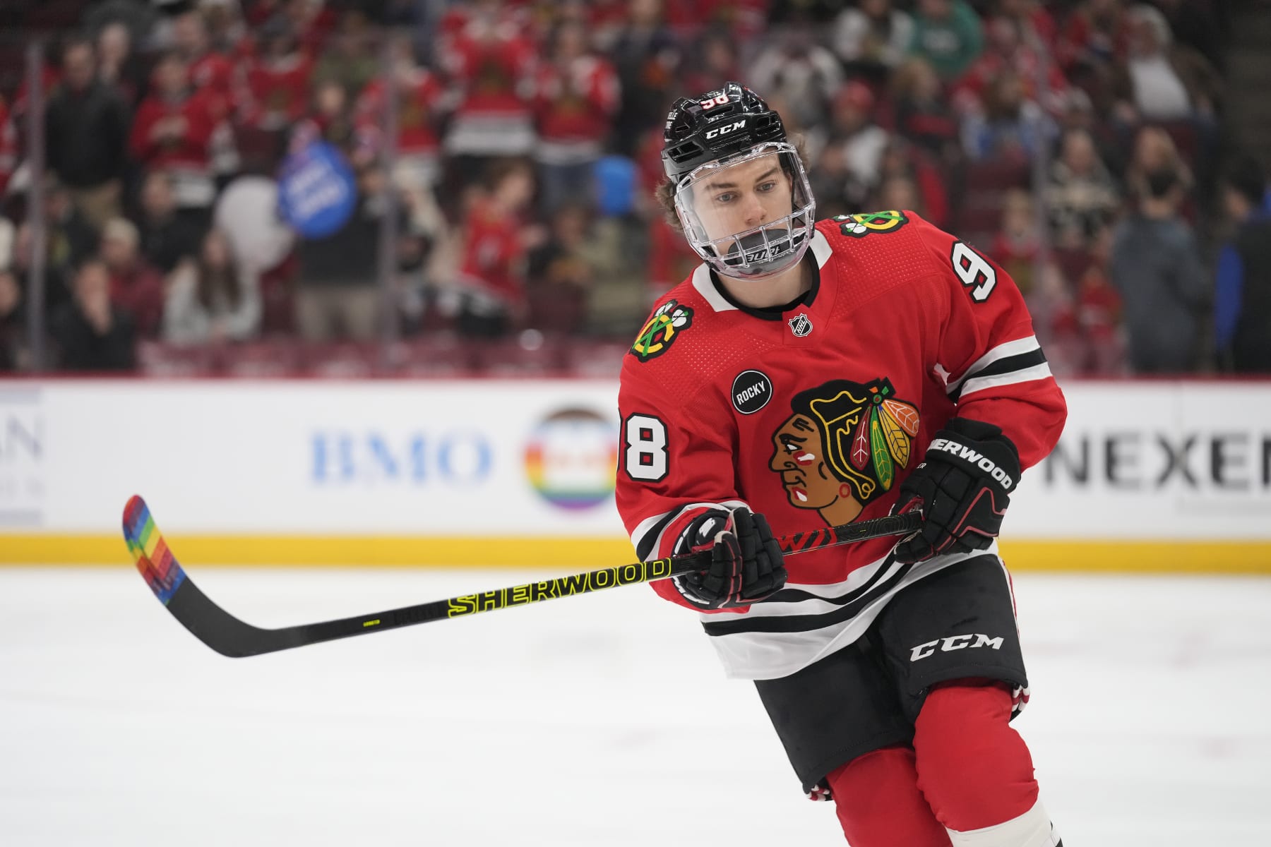 CHICAGO, ILLINOIS - MARCH 26: Connor Bedard #98 of the Chicago Blackhawks warms up with pride tape on his stick before a game against the Calgary Flames at the United Center on March 26, 2024 in Chicago, Illinois. (Photo by Patrick McDermott/Getty Images)