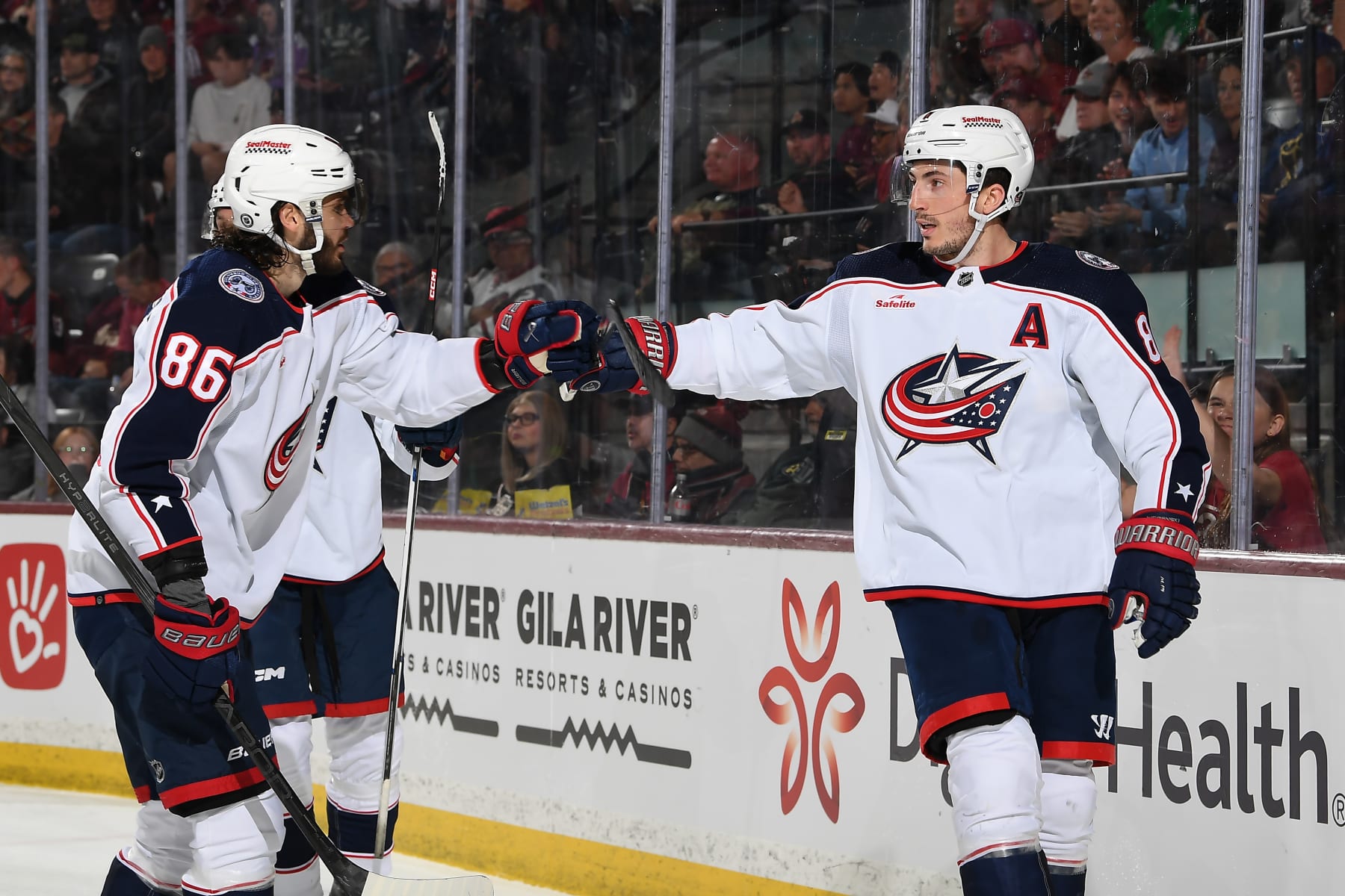 TEMPE, ARIZONA - MARCH 26: Zach Werenski #8 of the Columbus Blue Jackets celebrates with teammate Kirill Marchenko #86 after scoring a goal against the Arizona Coyotes during the second period of the game at Mullett Arena on March 26, 2024 in Tempe, Arizona. (Photo by Norm Hall/NHLI via Getty Images)