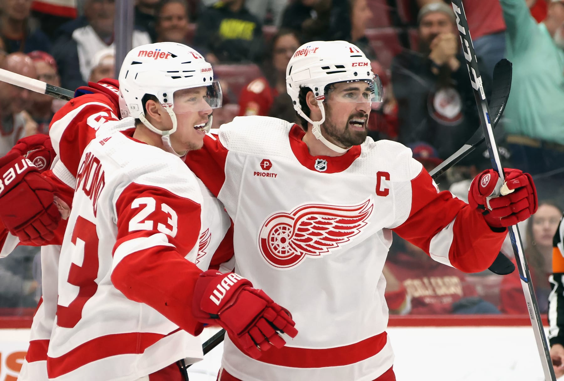 SUNRISE, FLORIDA - MARCH 30: Dylan Larkin #71 of the Detroit Red Wings (R) celebrates his powerplay goal against the Florida Panthers at 16:00 of the third period and is joined by Lucas Raymond #23 (L) at Amerant Bank Arena on March 30, 2024 in Sunrise, Florida. The Panthers defeated the Red Wings 3-2 in the shootout. (Photo by Bruce Bennett/Getty Images)