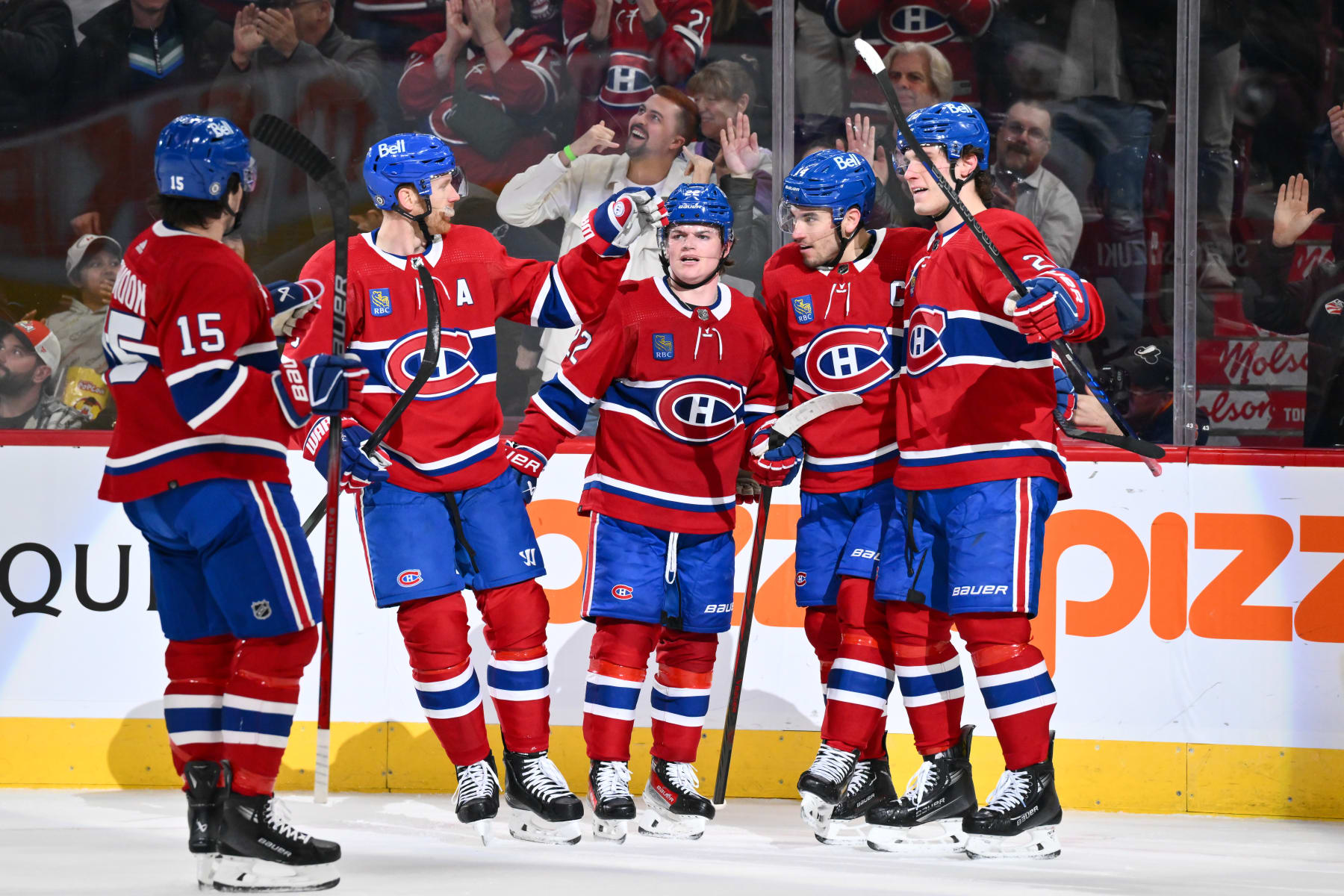 MONTREAL, CANADA - APRIL 02:  Nick Suzuki #14 of the Montreal Canadiens celebrates his goal with teammates Alex Newhook #15, Mike Matheson #8, Cole Caufield #22 and Juraj Slafkovsky #20 during the second period against the Florida Panthers at the Bell Centre on April 2, 2024 in Montreal, Quebec, Canada.  (Photo by Minas Panagiotakis/Getty Images)