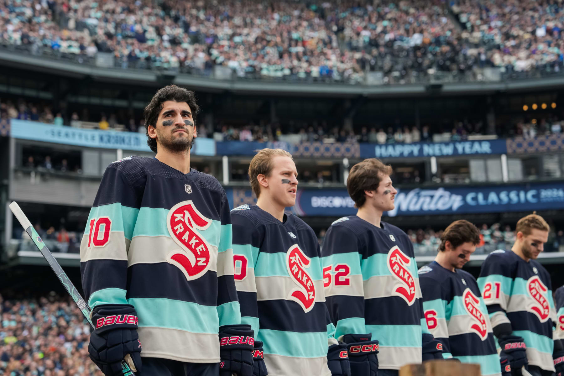 SEATTLE, WASHINGTON - JANUARY 01: Matty Beniers #10 of the Seattle Kraken stands for the national anthem before the 2024 Discover NHL Winter Classic against the Vegas Golden Knights at T-Mobile Park on January 01, 2024 in Seattle, Washington. (Photo by Christopher Mast/NHLI via Getty Images)