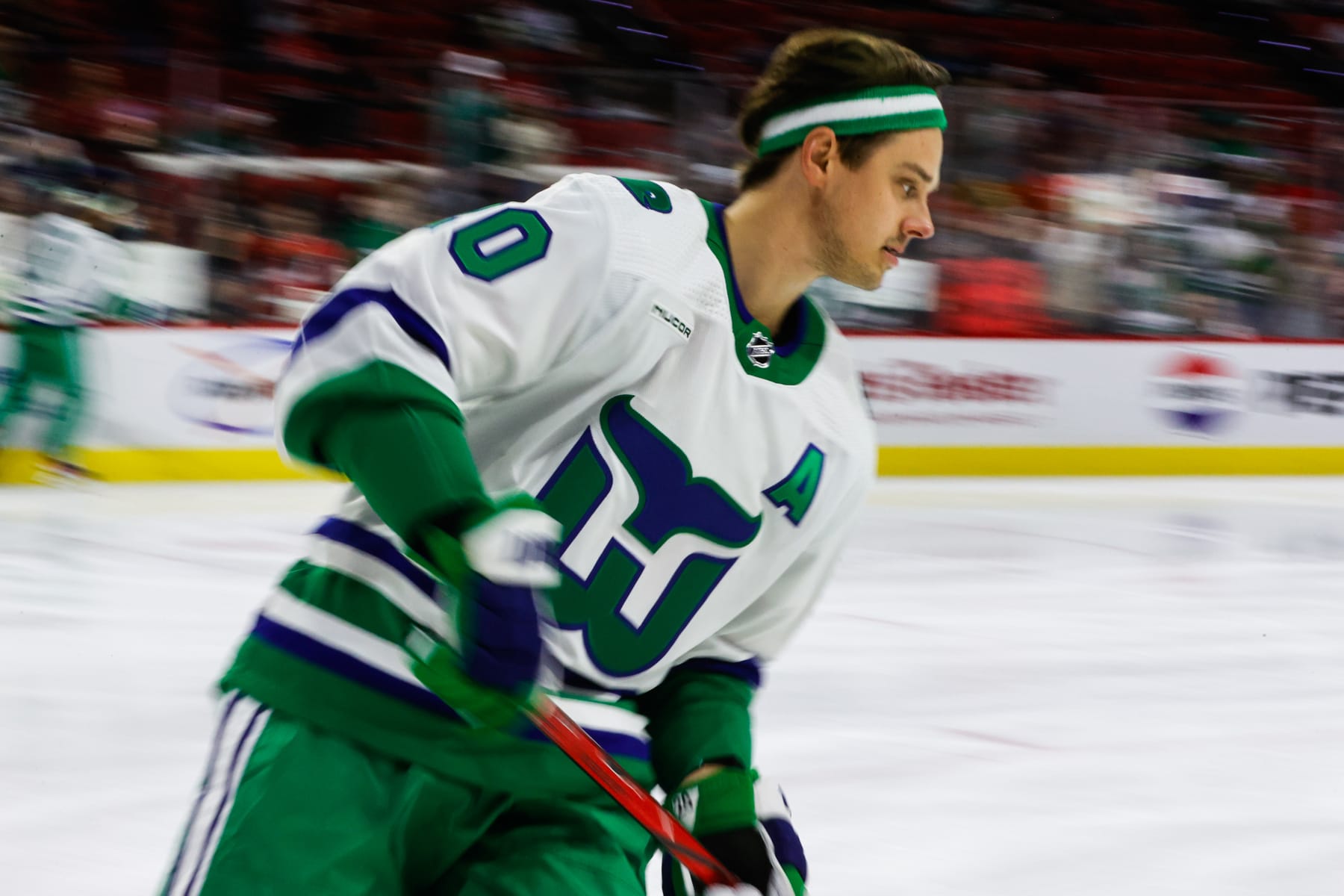 RALEIGH, NC - FEBRUARY 10: Sebastian Aho #20 of the Carolina Hurricanes skates in Whalers jerseys during warmups before the the game against the New Jersey Devils at PNC Arena on February 10, 2024 in Raleigh, North Carolina. (Photo by Jaylynn Nash/Getty Images)