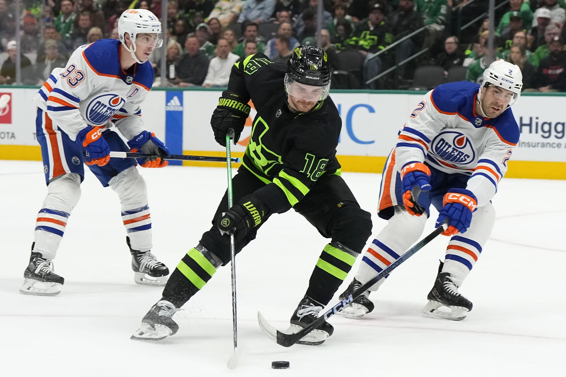 DALLAS, TEXAS - APRIL 03: Sam Steel #18 of the Dallas Stars skates the puck against Evan Bouchard #2 of the Edmonton Oilers during the first period at American Airlines Center on April 03, 2024 in Dallas, Texas. (Photo by Sam Hodde/Getty Images)