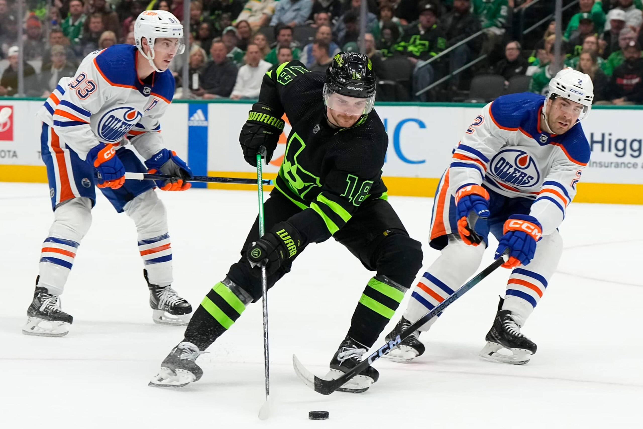DALLAS, TEXAS - APRIL 03: Sam Steel #18 of the Dallas Stars skates the puck against Evan Bouchard #2 of the Edmonton Oilers during the first period at American Airlines Center on April 03, 2024 in Dallas, Texas. (Photo by Sam Hodde/Getty Images)