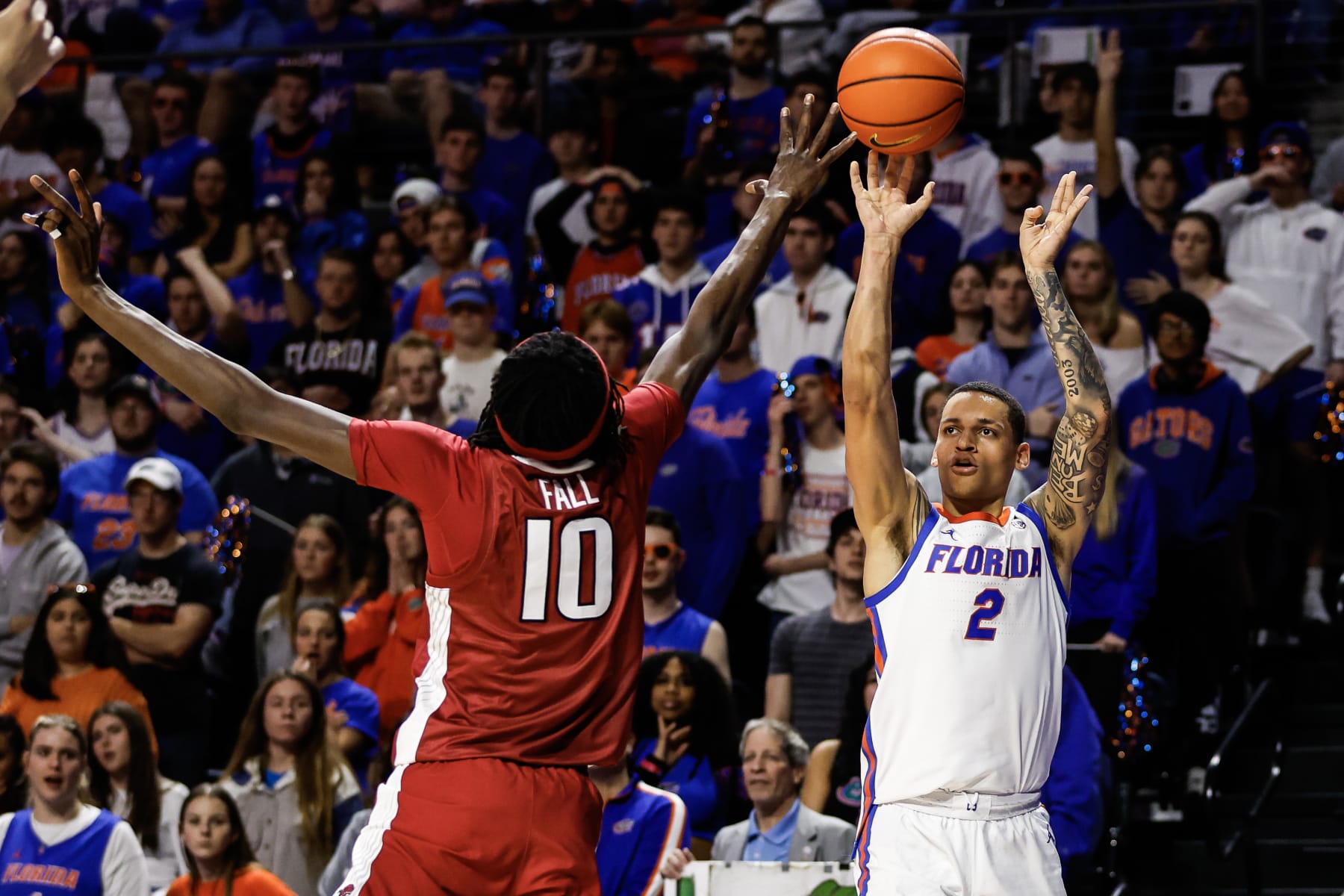 GAINESVILLE, FLORIDA - JANUARY 13: Riley Kugel #2 of the Florida Gators shoots the ball against Baye Fall #10 of the Arkansas Razorbacks during the second half of a game at the Stephen C. O'Connell Center on January 13, 2024 in Gainesville, Florida. (Photo by James Gilbert/Getty Images)