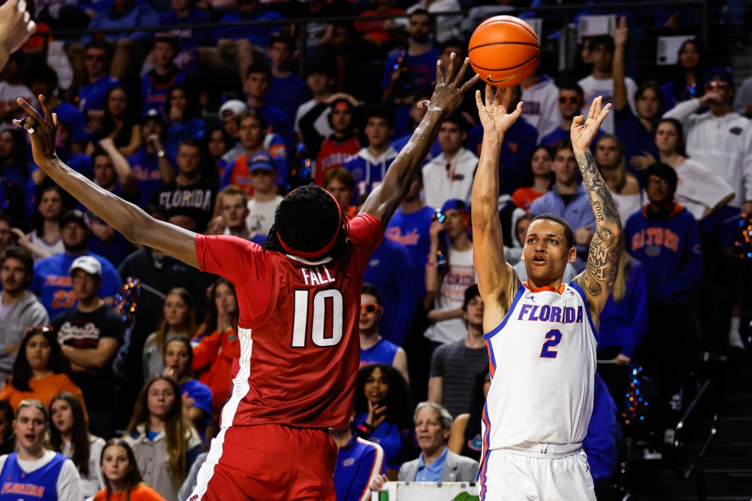 GAINESVILLE, FLORIDA - JANUARY 13: Riley Kugel #2 of the Florida Gators shoots the ball against Baye Fall #10 of the Arkansas Razorbacks during the second half of a game at the Stephen C. O'Connell Center on January 13, 2024 in Gainesville, Florida. (Photo by James Gilbert/Getty Images) GAINESVILLE, FLORIDA - JANUARY 13: Riley Kugel #2 of the Florida Gators shoots the ball against Baye Fall #10 of the Arkansas Razorbacks during the second half of a game at the Stephen C. O'Connell Center on January 13, 2024 in Gainesville, Florida. (Photo by James Gilbert/Getty Images)