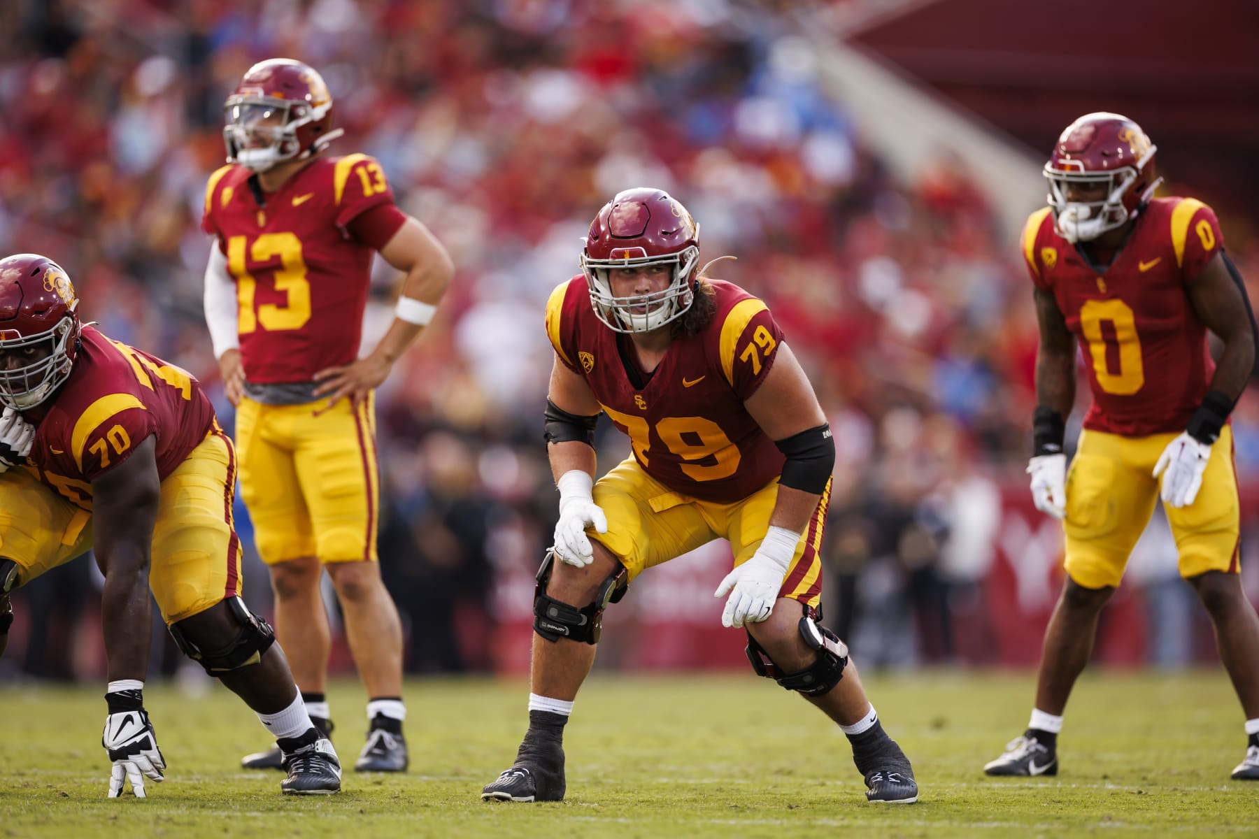 LOS ANGELES, CALIFORNIA - NOVEMBER 18: Jonah Monheim #79 of the USC Trojans gets set to block during the first half of a game against the UCLA Bruins at United Airlines Field at the Los Angeles Memorial Coliseum on November 18, 2023 in Los Angeles, California. (Photo by Ryan Kang/Getty Images)