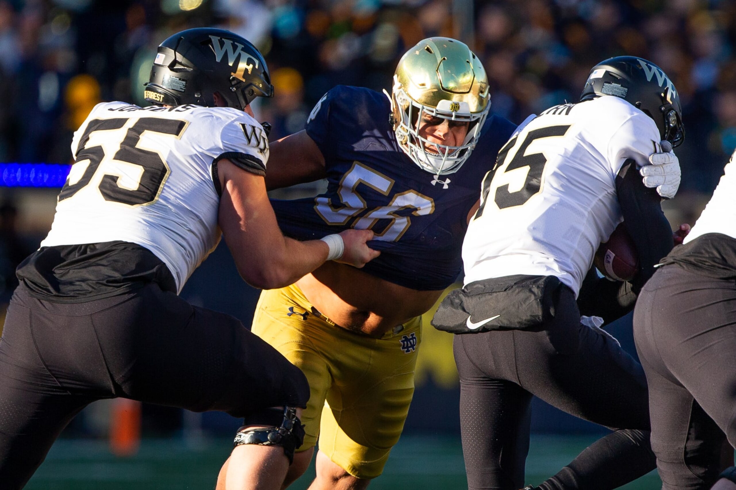 SOUTH BEND, IN - NOVEMBER 18: Howard Cross #56 of Notre Dame makes a tackle on Michael Kern #15 of Wake Forest during a game between Wake Forest University and University of Notre Dame at Notre Dame Stadium on November 18, 2023 in South Bend, Indiana. (Photo by Michael Miller/ISI Photos/Getty Images)