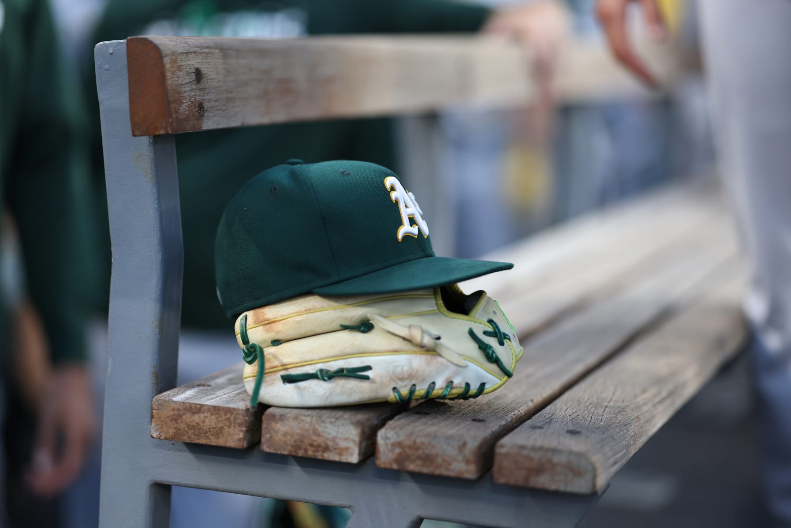 LOS ANGELES, CALIFORNIA - AUGUST 02: A general view of an Oakland Athletics glove and hat in the dugout prior to a game against the Los Angeles Dodgers at Dodger Stadium on August 02, 2023 in Los Angeles, California. (Photo by Michael Owens/Getty Images)
