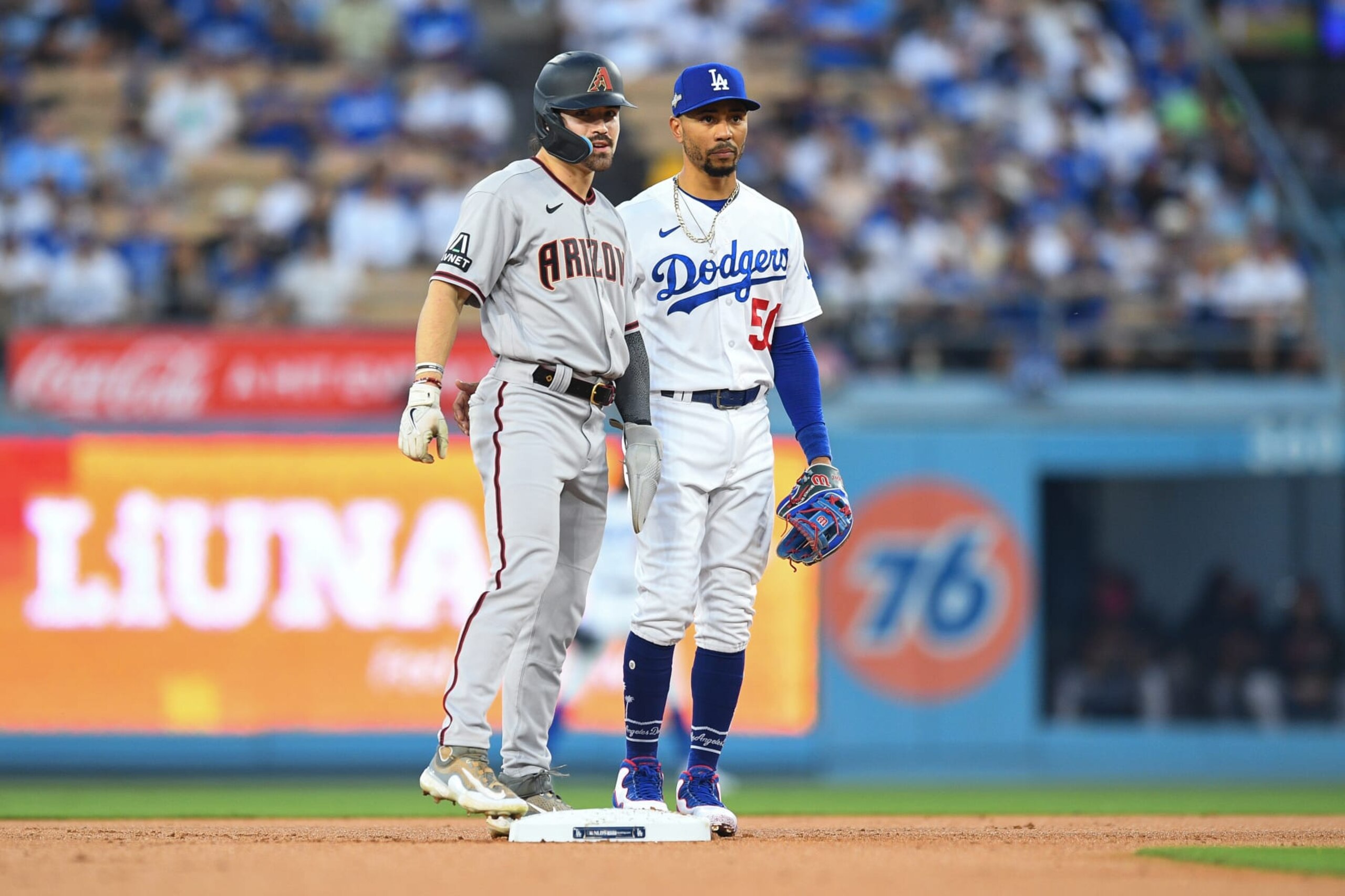 LOS ANGELES, CA - OCTOBER 07: Arizona Diamondbacks right fielder Corbin Carroll (7) looks on with Los Angeles Dodgers second baseman Mookie Betts (50) during the MLB NLDS Game 1 between the Arizona Diamondbacks and the Los Angeles Dodgers on October 7, 2023 at Dodger Stadium in Los Angeles, CA. (Photo by Brian Rothmuller/Icon Sportswire via Getty Images) LOS ANGELES, CA - OCTOBER 07: Arizona Diamondbacks right fielder Corbin Carroll (7) looks on with Los Angeles Dodgers second baseman Mookie Betts (50) during the MLB NLDS Game 1 between the Arizona Diamondbacks and the Los Angeles Dodgers on October 7, 2023 at Dodger Stadium in Los Angeles, CA. (Photo by Brian Rothmuller/Icon Sportswire via Getty Images)