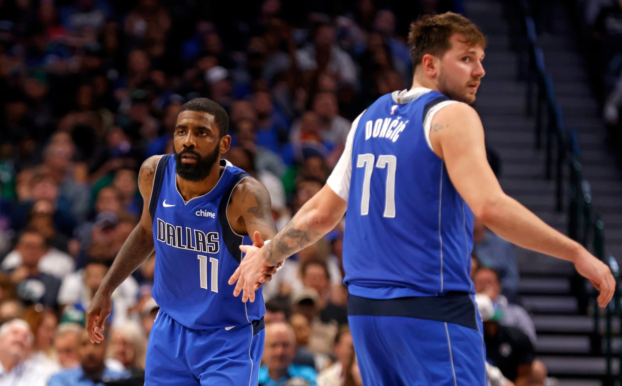 DALLAS, TX - APRIL 04: Kyrie Irving #11 and teammate Luka Doncic #77 of the Dallas Mavericks celebrate a basket against the Atlanta Hawks in the second half at American Airlines Center on April 4, 2024 in Dallas, Texas. NOTE TO USER: User expressly acknowledges and agrees that, by downloading and or using this photograph, User is consenting to the terms and conditions of the Getty Images License Agreement. (Photo by Ron Jenkins/Getty Images)