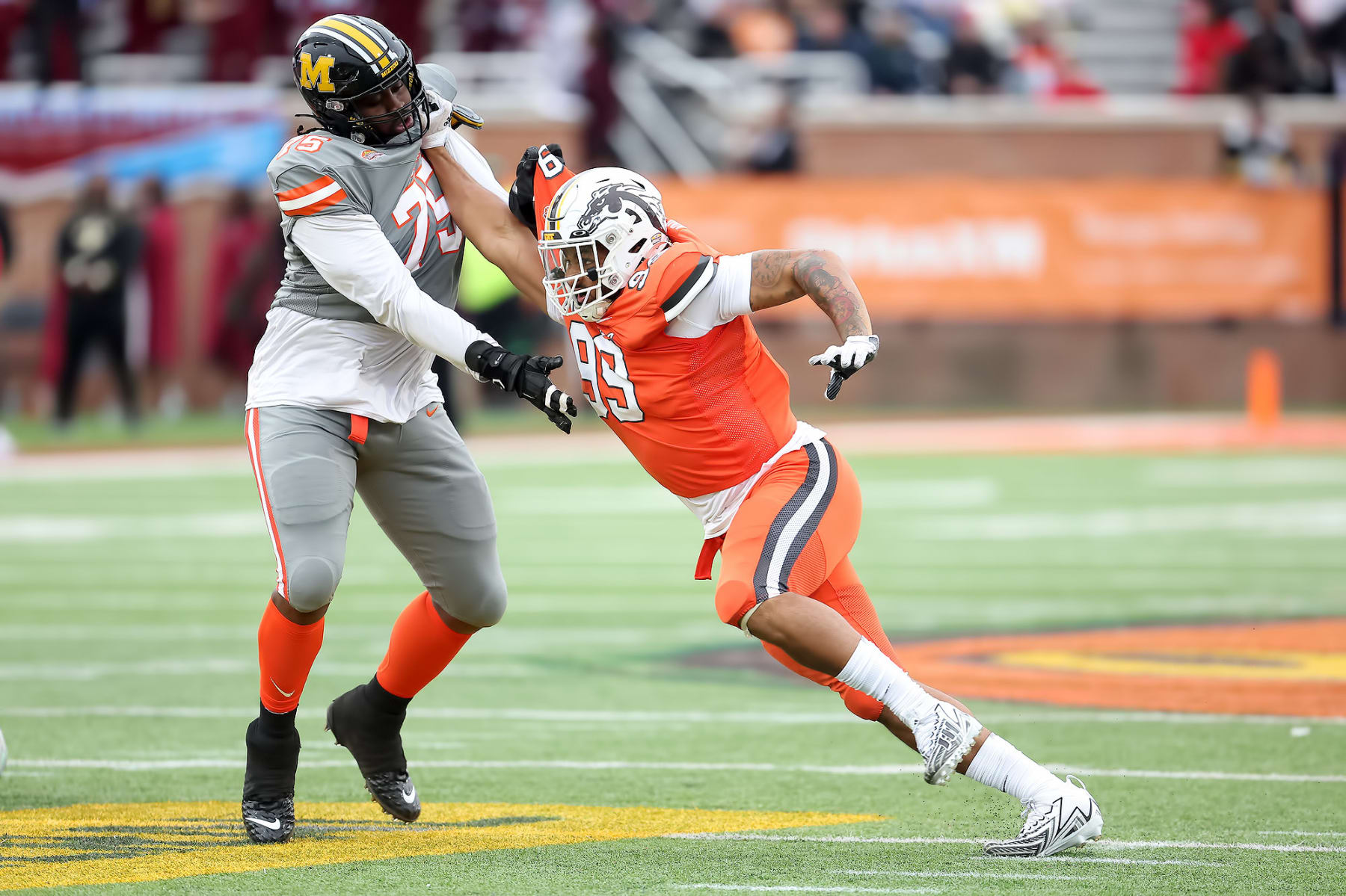 MOBILE, AL - FEBRUARY 03: National edge Marshawn Kneeland of Western Michigan (99) fights off the block from American offensive lineman Javon Foster of Missouri (75) during the the 2024 Reese's Senior Bowl on February 3, 2024 at Hancock Whitney Stadium in Mobile, Alabama.  (Photo by Michael Wade/Icon Sportswire via Getty Images)
