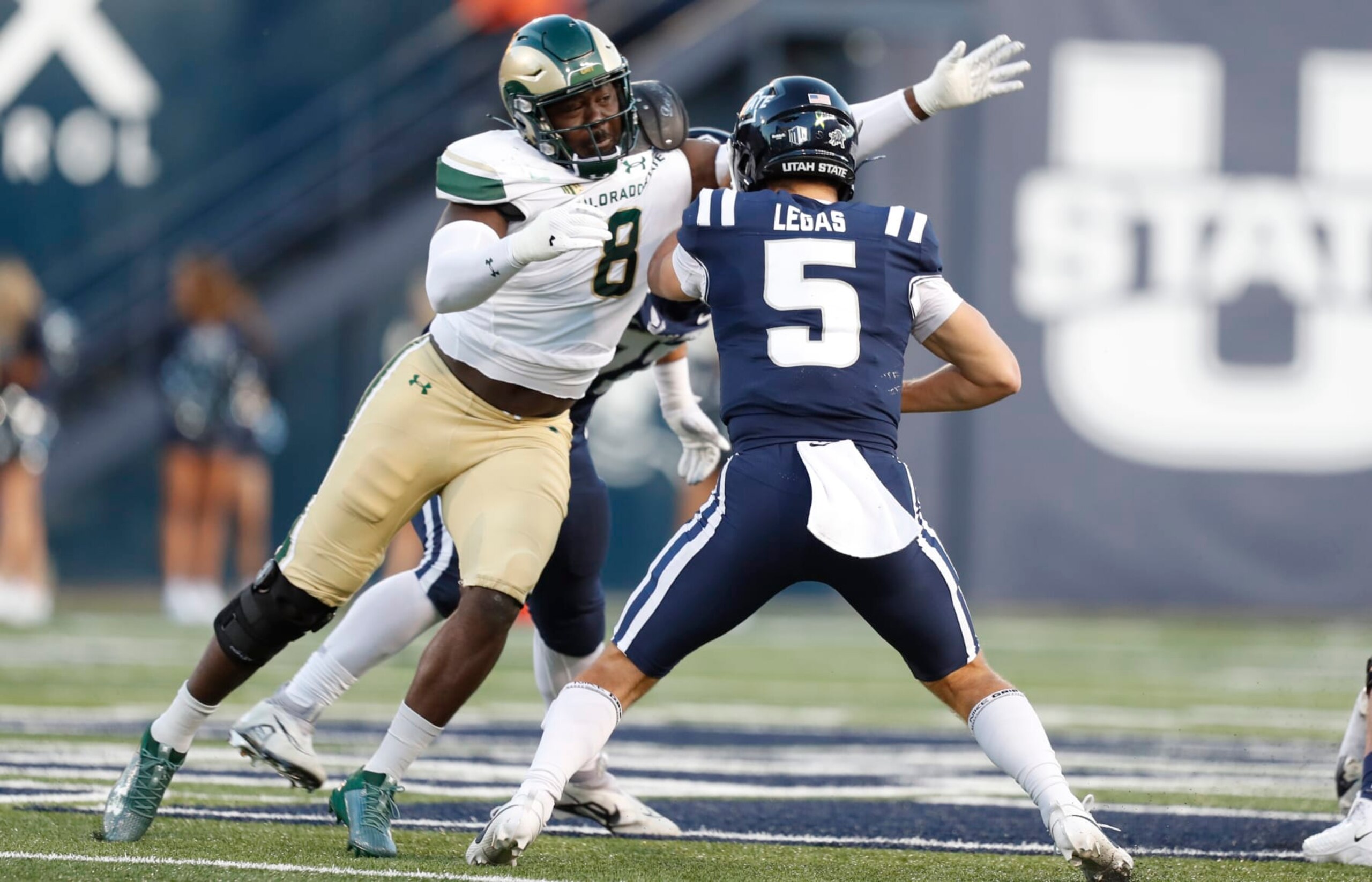 LOGAN, UT - OCTOBER 7: Cooper Legas #5 of the Utah State Aggies is sacked by Mohamed Kamara #8 of the Colorado State Rams during the first half of their game at Maverik Stadium October 7, 2023 in Logan, Utah. (Photo by Chris Gardner/Getty Images) LOGAN, UT - OCTOBER 7: Cooper Legas #5 of the Utah State Aggies is sacked by Mohamed Kamara #8 of the Colorado State Rams during the first half of their game at Maverik Stadium October 7, 2023 in Logan, Utah. (Photo by Chris Gardner/Getty Images)