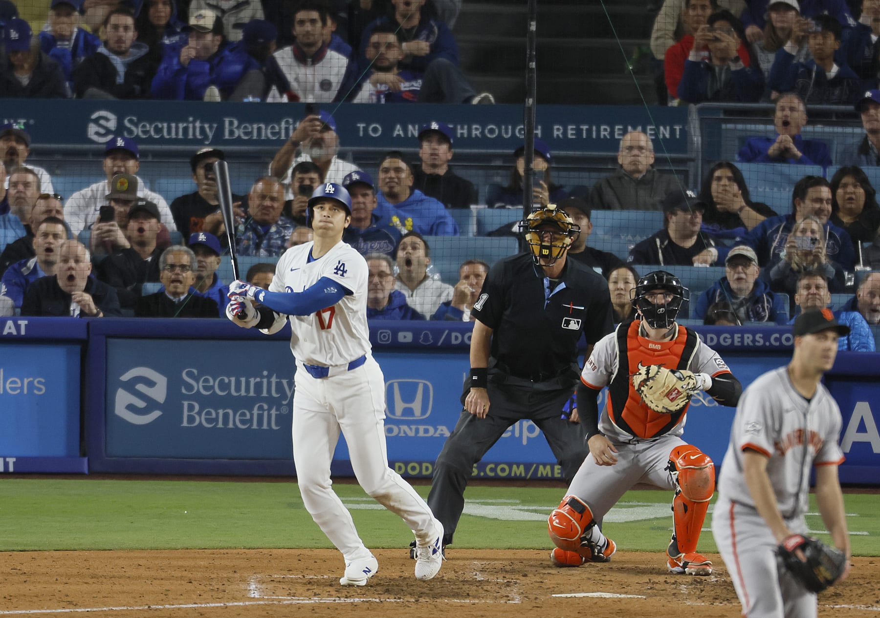 Los Angeles, CA - April 03: Dodgers designated hitter Shohei Ohtani, #17, hits his first home run as a Dodger off of Giants pitcher Taylor Rogers, # 33, in the seventh inning at Dodger Stadium in Los Angeles Wednesday, April 3, 2024. (Allen J. Schaben / Los Angeles Times via Getty Images)