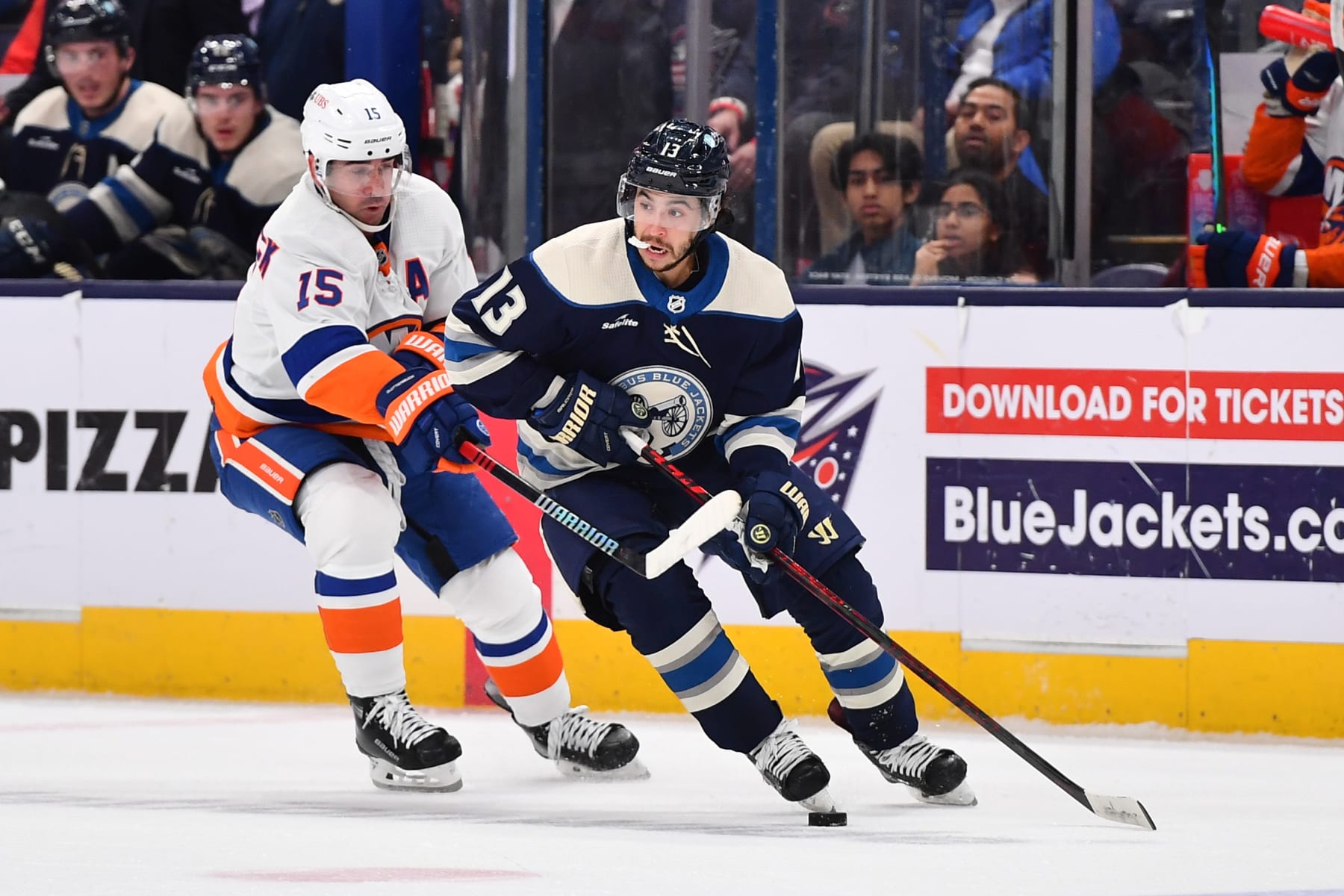 COLUMBUS, OHIO - OCTOBER 28: Johnny Gaudreau #13 of the Columbus Blue Jackets skates with the puck as Cal Clutterbuck #15 of the New York Islanders defends during the second period of a game at Nationwide Arena on October 28, 2023 in Columbus, Ohio. (Photo by Ben Jackson/NHLI via Getty Images)
