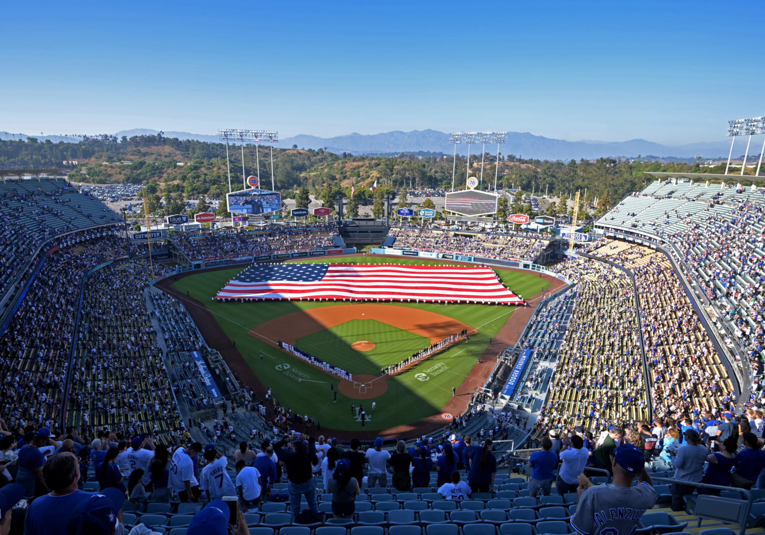 LOS ANGELES, CALIFORNIA - JULY 4: An American flag is held by members of the military during the National Anthem prior to the game between the Los Angeles Dodgers and the Pittsburgh Pirates at Dodger Stadium on July 4, 2023 in Los Angeles, California. (Photo by Jayne Kamin-Oncea/Getty Images)
