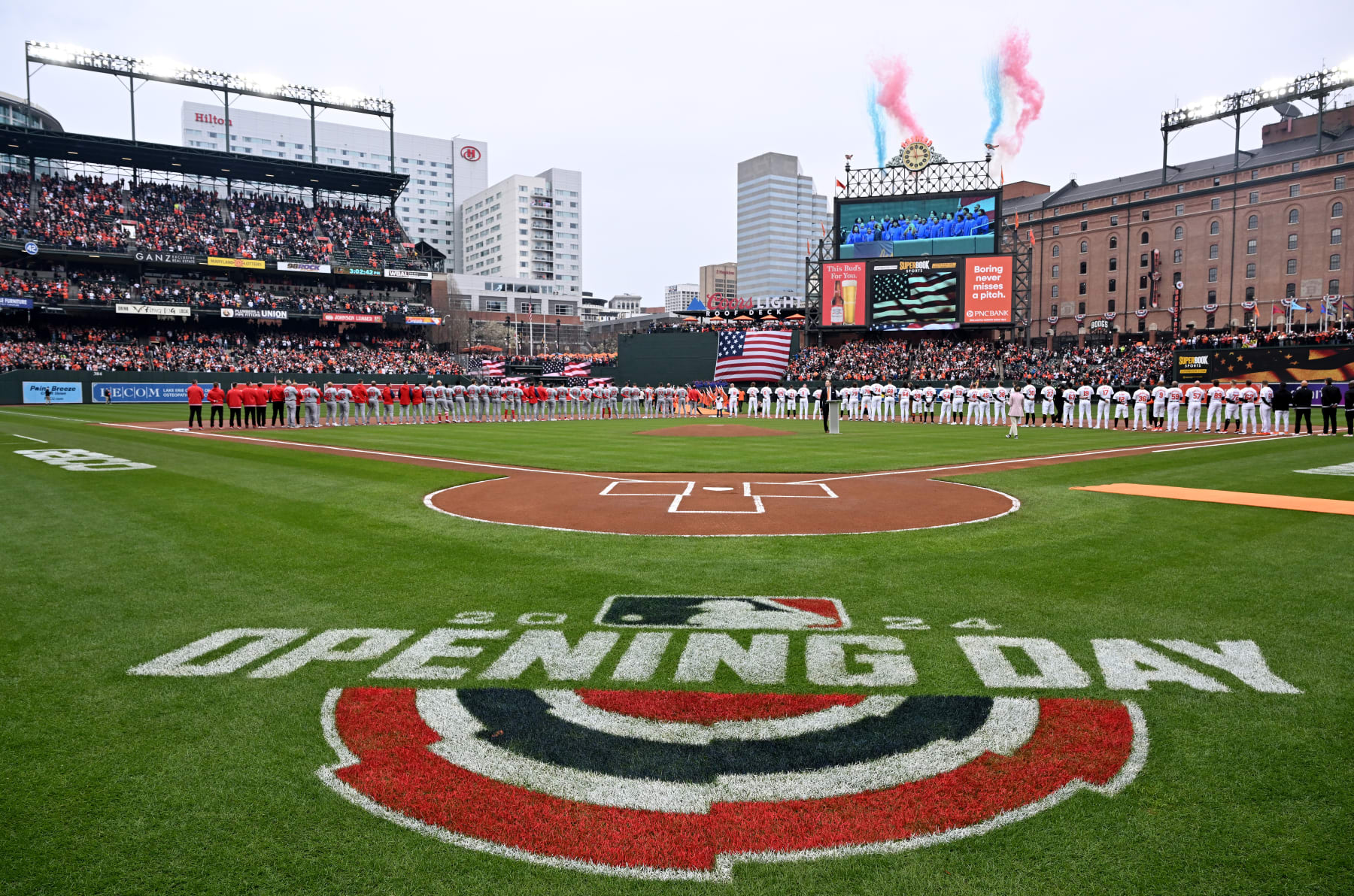 BALTIMORE, MARYLAND - MARCH 28: The Baltimore Orioles and Los Angeles Angels stand for the national anthem on Opening Day at Oriole Park at Camden Yards on March 28, 2024 in Baltimore, Maryland. (Photo by Greg Fiume/Getty Images)
