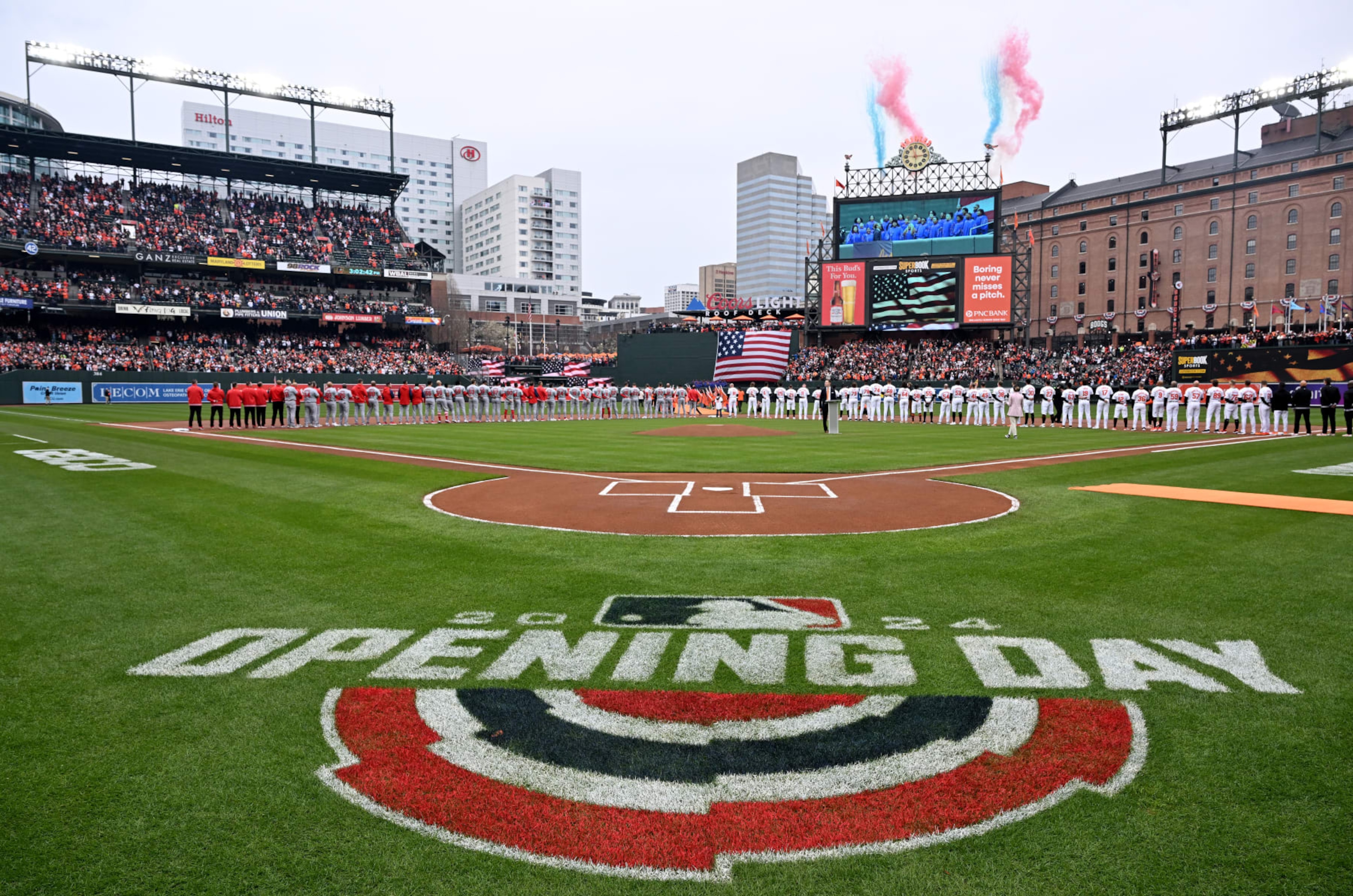 BALTIMORE, MARYLAND - MARCH 28: The Baltimore Orioles and Los Angeles Angels stand for the national anthem on Opening Day at Oriole Park at Camden Yards on March 28, 2024 in Baltimore, Maryland. (Photo by Greg Fiume/Getty Images) BALTIMORE, MARYLAND - MARCH 28: The Baltimore Orioles and Los Angeles Angels stand for the national anthem on Opening Day at Oriole Park at Camden Yards on March 28, 2024 in Baltimore, Maryland. (Photo by Greg Fiume/Getty Images)