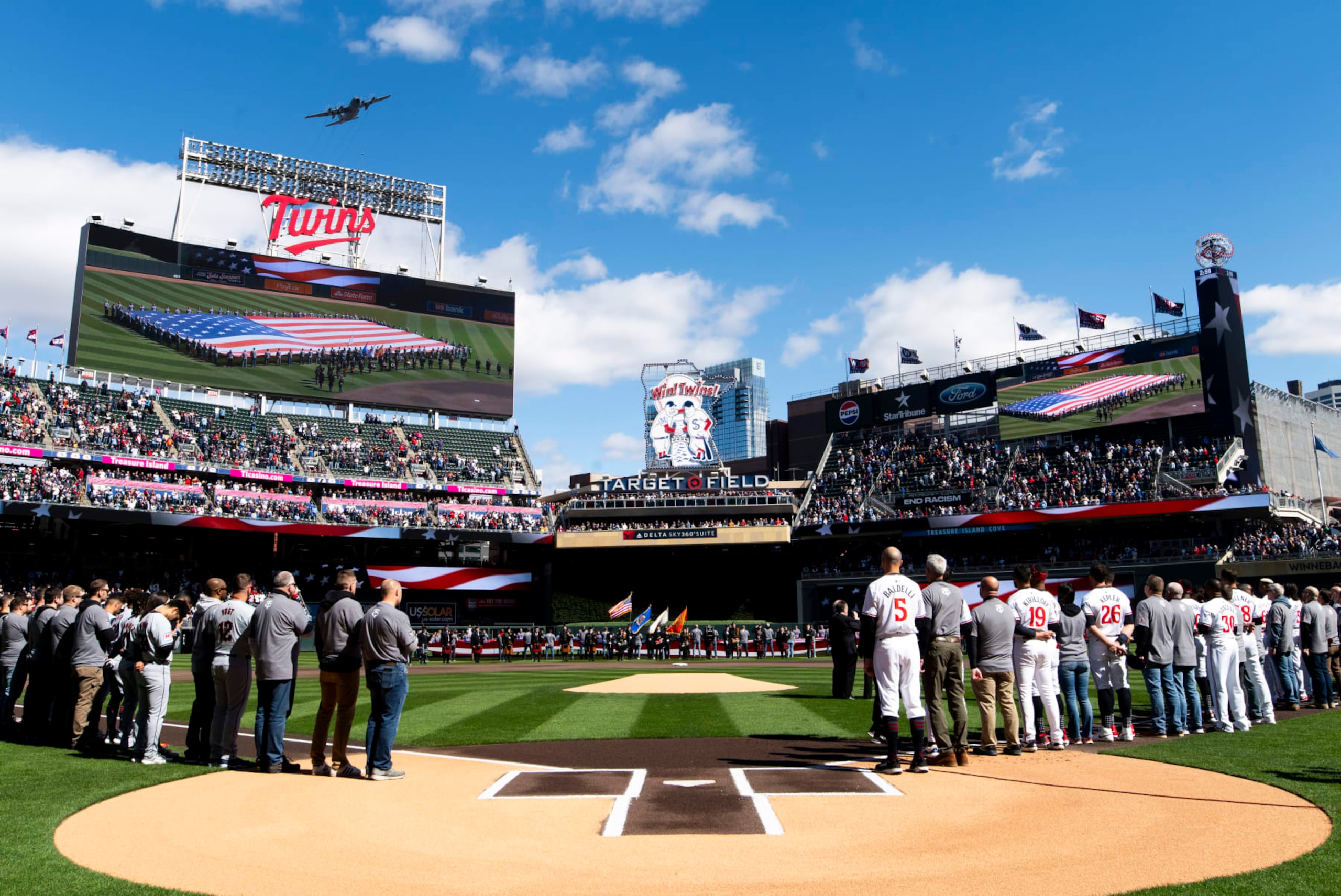 MINNEAPOLIS, MINNESOTA - APRIL 4: Members of the Minnesota Twins line up for the national anthem before the home opener at Target Field on April 4, 2024 in Minneapolis, Minnesota. (Photo by Stephen Maturen/Getty Images)