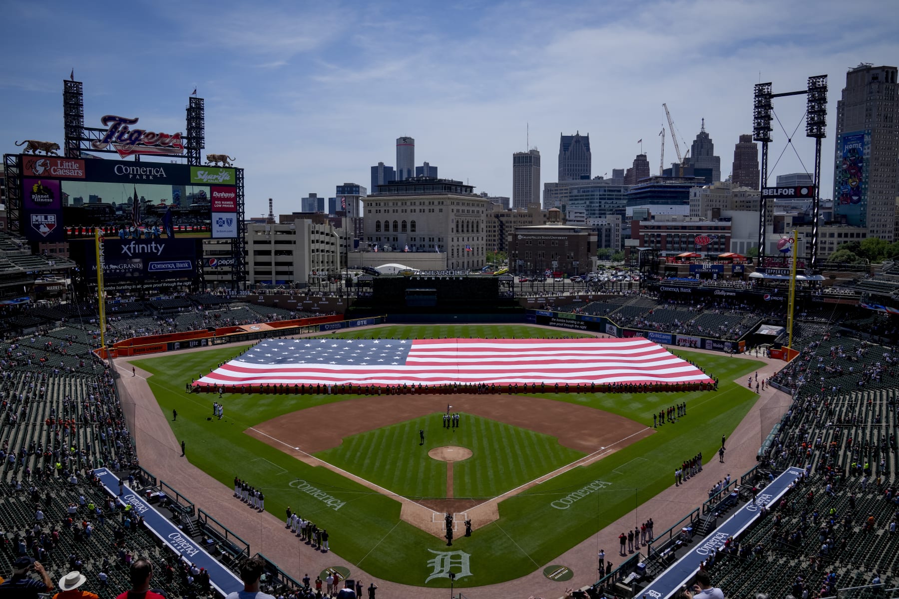 DETROIT, MICHIGAN - JULY 04: The American flag is presented during the national anthem before the game between the Detroit Tigers and Cleveland Guardians at Comerica Park on July 04, 2022 in Detroit, Michigan. (Photo by Nic Antaya/Getty Images)